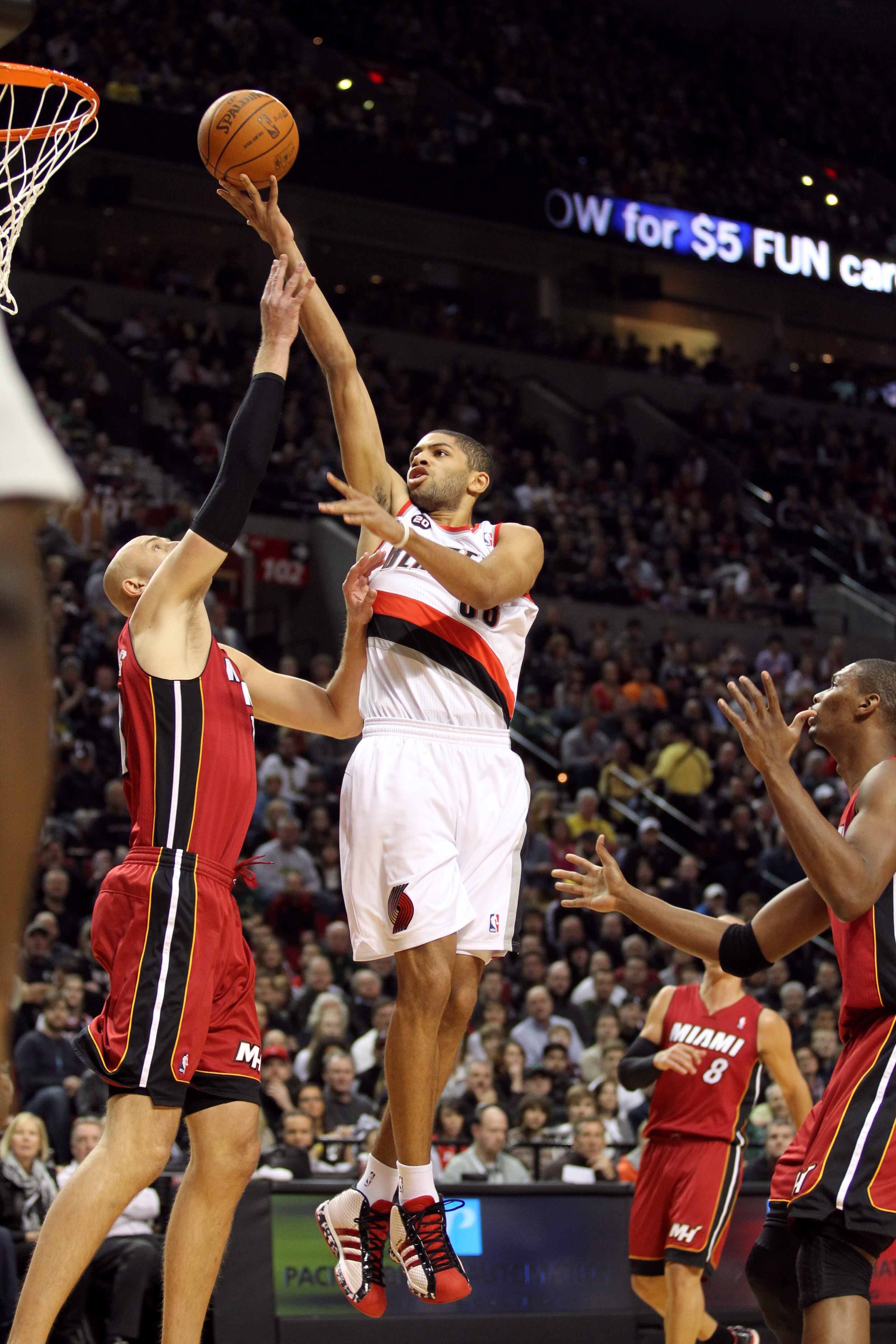PORTLAND, OR - JANUARY 09: Nicolas Batum #88 of the Portland Trail Blazers lays it up over Zydrunas Ilgauskas #11 of the Miami Heat during a game on January 9, 2011 at the Rose Garden Arena in Portland, Oregon. NOTE TO USER: User expressly acknowledges an