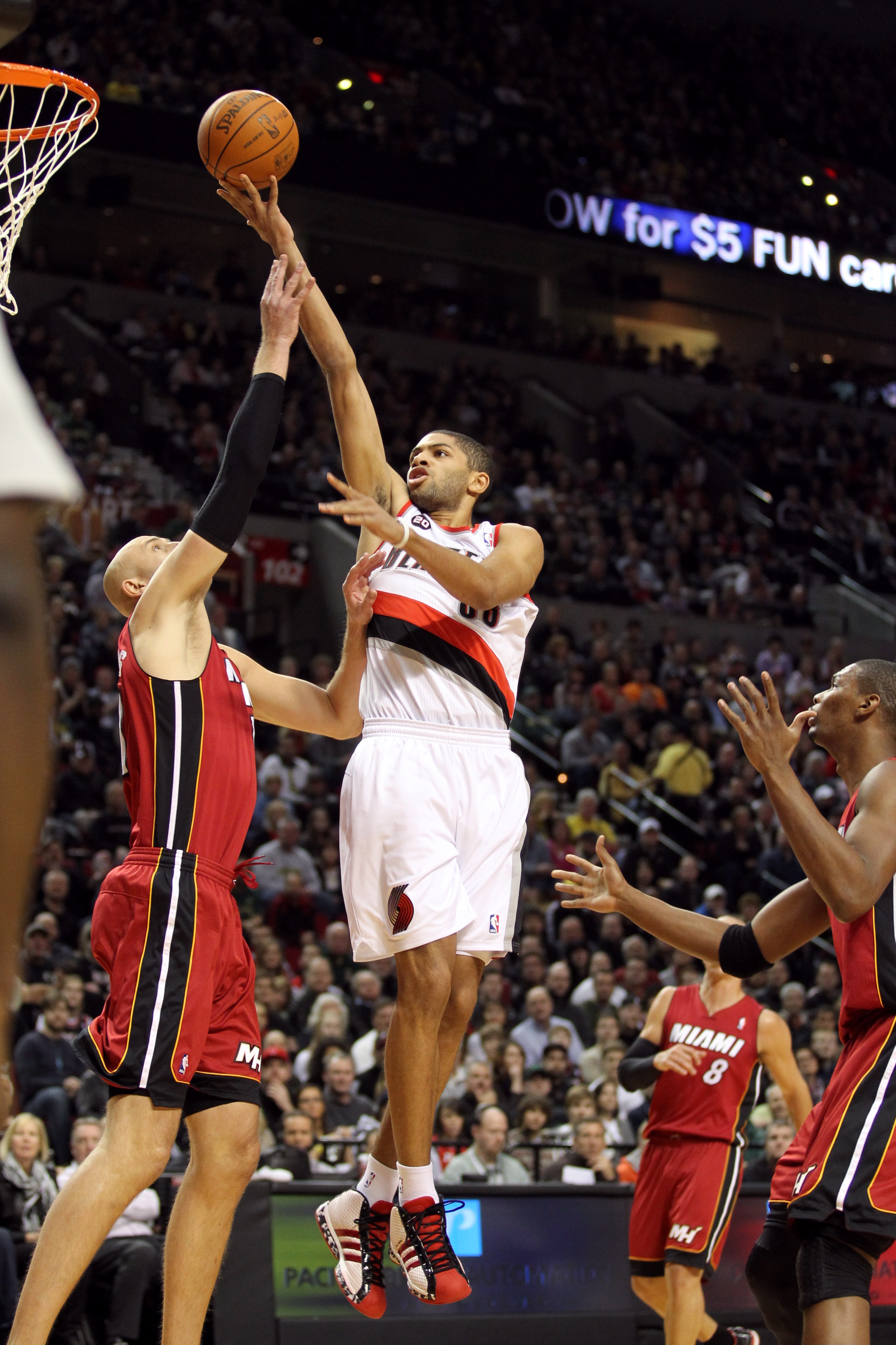 PORTLAND, OR - JANUARY 09: Nicolas Batum #88 of the Portland Trail Blazers lays it up over Zydrunas Ilgauskas #11 of the Miami Heat during a game on January 9, 2011 at the Rose Garden Arena in Portland, Oregon. NOTE TO USER: User expressly acknowledges an