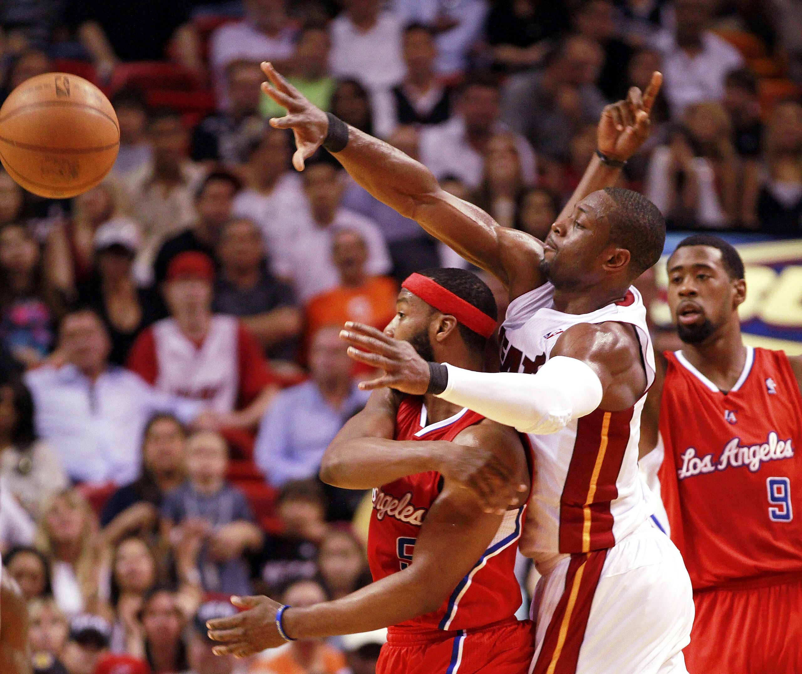 MIAMI - FEBRUARY 06: Guard Dwyane Wade #3 of the Miami Heat defends against guard Baron davis #5 of the L.A. Clippers at American Airlines Arena on February 6, 2011 in Miami, Florida. NOTE TO USER: User expressly acknowledges and agrees that, by download MIAMI - FEBRUARY 06: Guard Dwyane Wade #3 of the Miami Heat defends against guard Baron davis #5 of the L.A. Clippers at American Airlines Arena on February 6, 2011 in Miami, Florida. NOTE TO USER: User expressly acknowledges and agrees that, by download