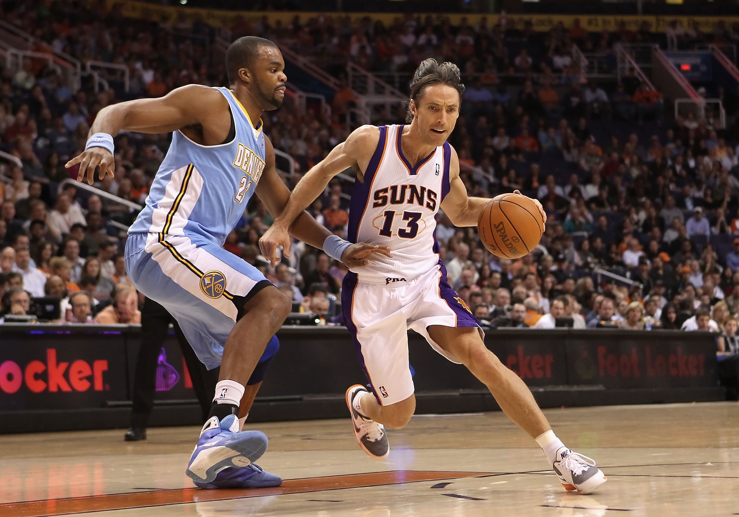 PHOENIX - NOVEMBER 15:  Steve Nash #13 of the Phoenix Suns handles the ball under pressure from Shelden Williams #23 of the Denver Nuggets during the NBA game at US Airways Center on November 15, 2010 in Phoenix, Arizona. The Suns defeated the Nuggets 100