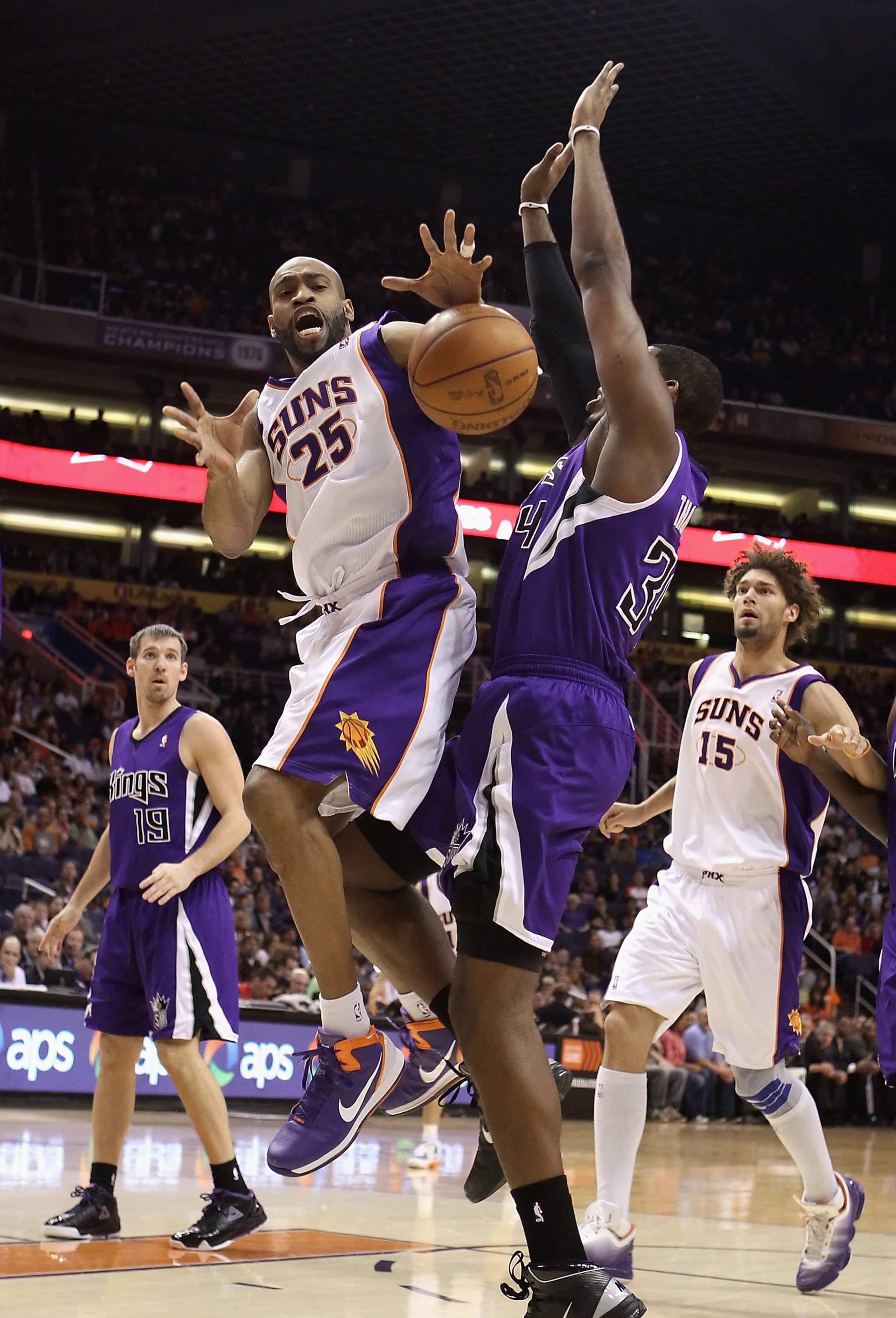PHOENIX, AZ - FEBRUARY 13:  Vince Carter #25 of the Phoenix Suns loses the ball as he drives to the basket against Jason Thompson #34 of the Sacramento Kings during the NBA game at US Airways Center on February 13, 2011 in Phoenix, Arizona.  NOTE TO USER: