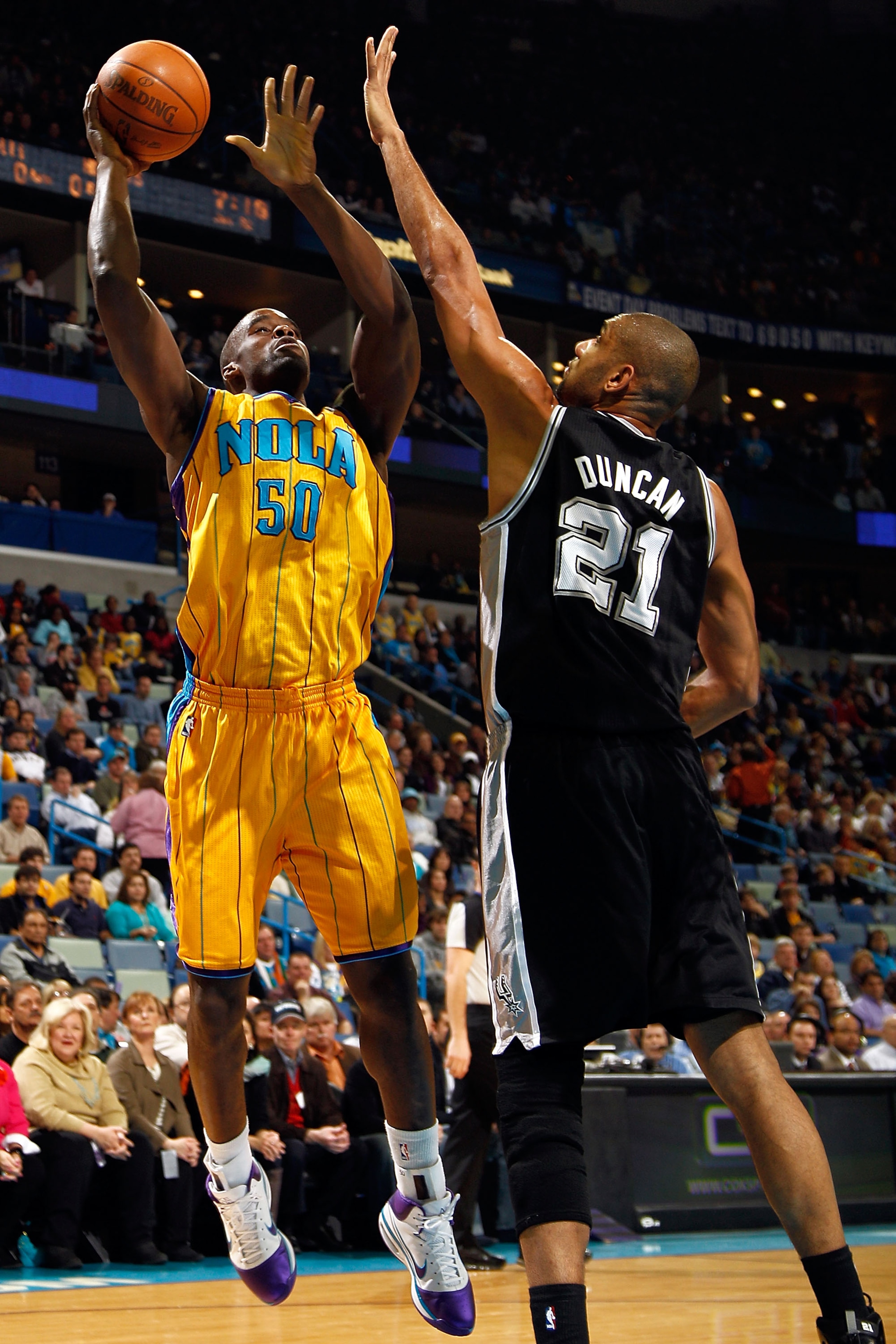 NEW ORLEANS, LA - JANUARY 22: Emeka Okafor #50 of the New Orleans Hornets shoots the ball over Tim Duncan #21 of the San Antonio Spurs at the New Orleans Arena on January 22, 2011 in New Orleans, Louisiana. NOTE TO USER: User expressly acknowledges and NEW ORLEANS, LA - JANUARY 22: Emeka Okafor #50 of the New Orleans Hornets shoots the ball over Tim Duncan #21 of the San Antonio Spurs at the New Orleans Arena on January 22, 2011 in New Orleans, Louisiana. NOTE TO USER: User expressly acknowledges and
