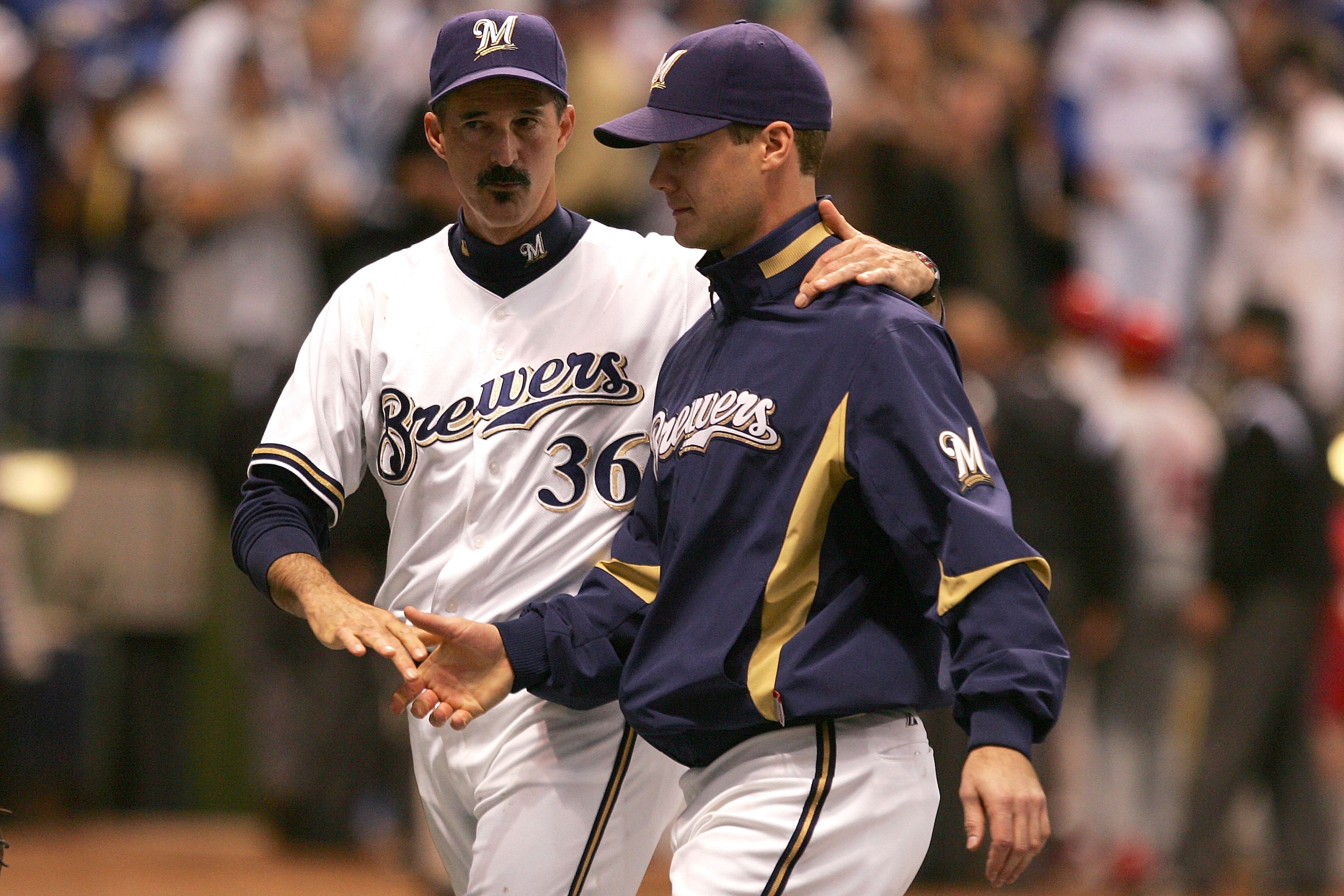 MILWAUKEE - OCTOBER 04:  (L-R) Pitching coach Mike Maddux #36 and Dave Bush #31 of the Milwaukee Brewers against the Philadelphia Phillies in Game three of the NLDS during the 2008 MLB playoffs at Miller Park on October 4, 2008 in Milwaukee, Wisconsin.  (