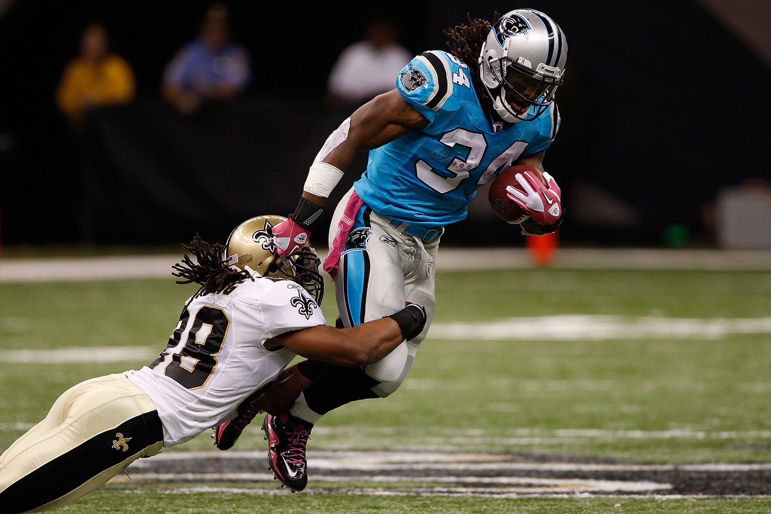 NEW ORLEANS - OCTOBER 03:  Usama Young #28 of the New Orleans Saints tackles DeAngelo Williams #34 of the Carolina Panthers at the Louisiana Superdome on October 3, 2010 in New Orleans, Louisiana.  (Photo by Chris Graythen/Getty Images)