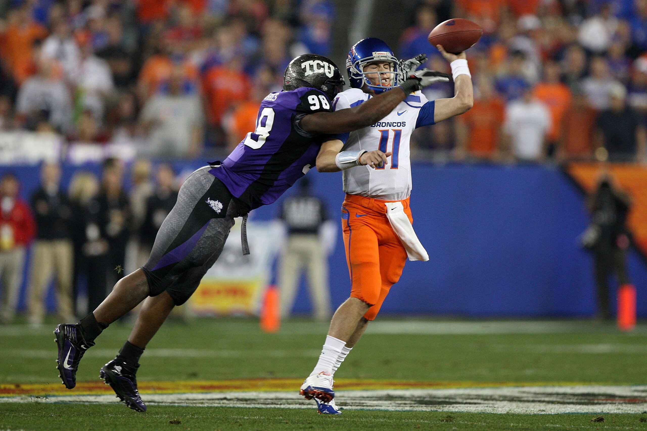 GLENDALE, AZ - JANUARY 04: Quarterback Kellen Moore #11 of the Boise State Broncos passes the ball in the second half as Jerry Hughes #98 of the TCU Horned Frogs rushes in during the Tostitos Fiesta Bowl at the Universtity of Phoenix Stadium on January 4 GLENDALE, AZ - JANUARY 04: Quarterback Kellen Moore #11 of the Boise State Broncos passes the ball in the second half as Jerry Hughes #98 of the TCU Horned Frogs rushes in during the Tostitos Fiesta Bowl at the Universtity of Phoenix Stadium on January 4