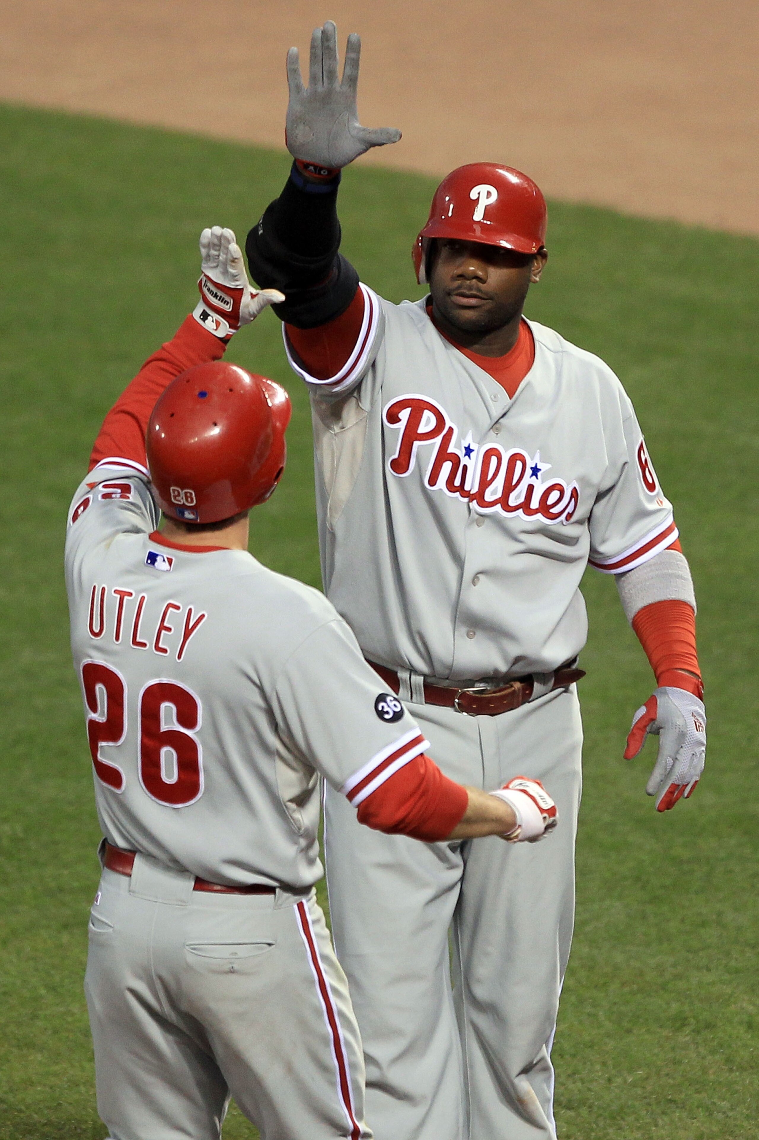 SAN FRANCISCO - OCTOBER 20:  (L-R) Chase Utley #26 and Ryan Howard #6 of the Philadelphia Phillies celebrate after Utley scored on a double by Placido Polanco #27 against the San Francisco Giants in the fifth inning of Game Four of the NLCS during the 201