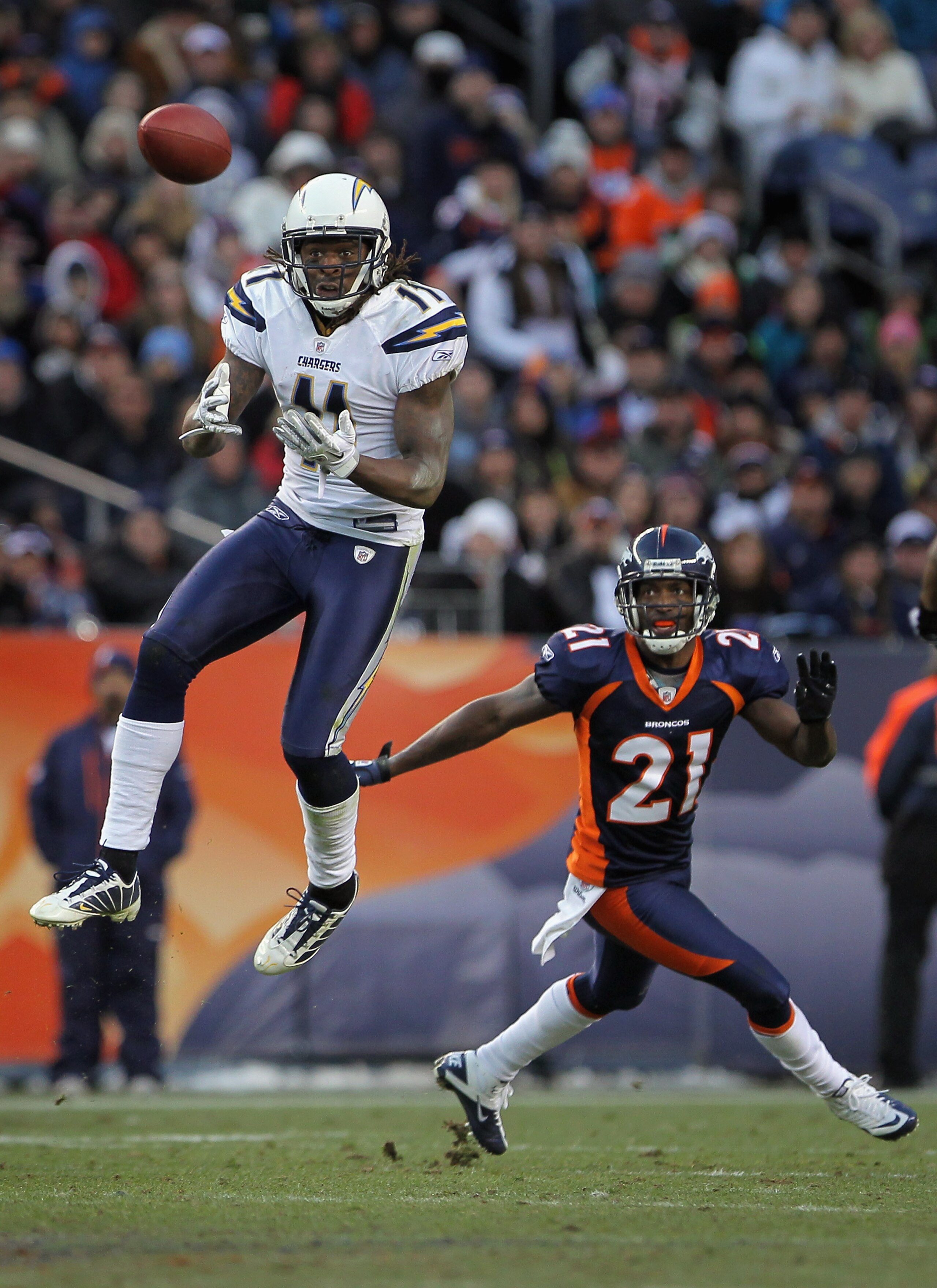 DENVER - JANUARY 02:  Wide receiver Legedu Naanee #11 of the San Diego Chargers makes a 26 yard reception for a first down in front of cornerback Andre Goodman #21 of the Denver Broncos in the third quarter at INVESCO Field at Mile High on January 2, 2011