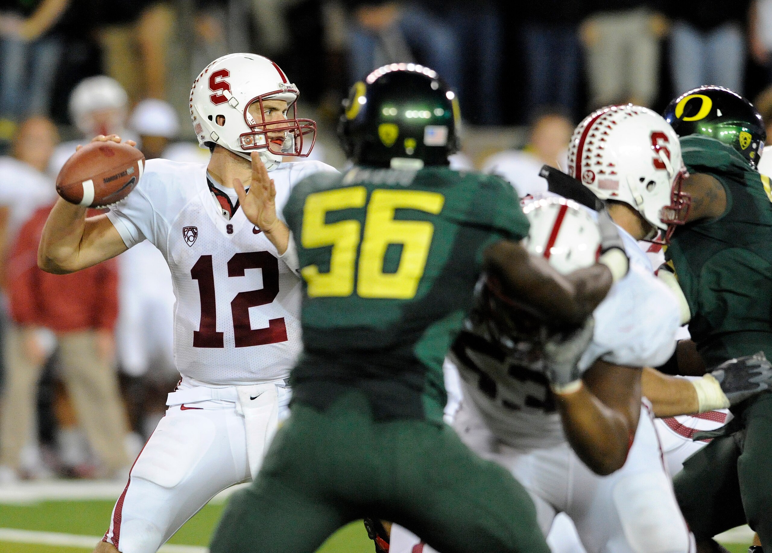 EUGENE, OR - OCTOBER 2: Quarterback Andrew Luck #12 of the Stanford Cardinal sets to throw a pass as linebacker Josh Kaddu #56 of the Oregon Ducks applies pressure in the third quarter of the game at Autzen Stadium on October 2, 2010 in Eugene, Oregon. Or EUGENE, OR - OCTOBER 2: Quarterback Andrew Luck #12 of the Stanford Cardinal sets to throw a pass as linebacker Josh Kaddu #56 of the Oregon Ducks applies pressure in the third quarter of the game at Autzen Stadium on October 2, 2010 in Eugene, Oregon. Or
