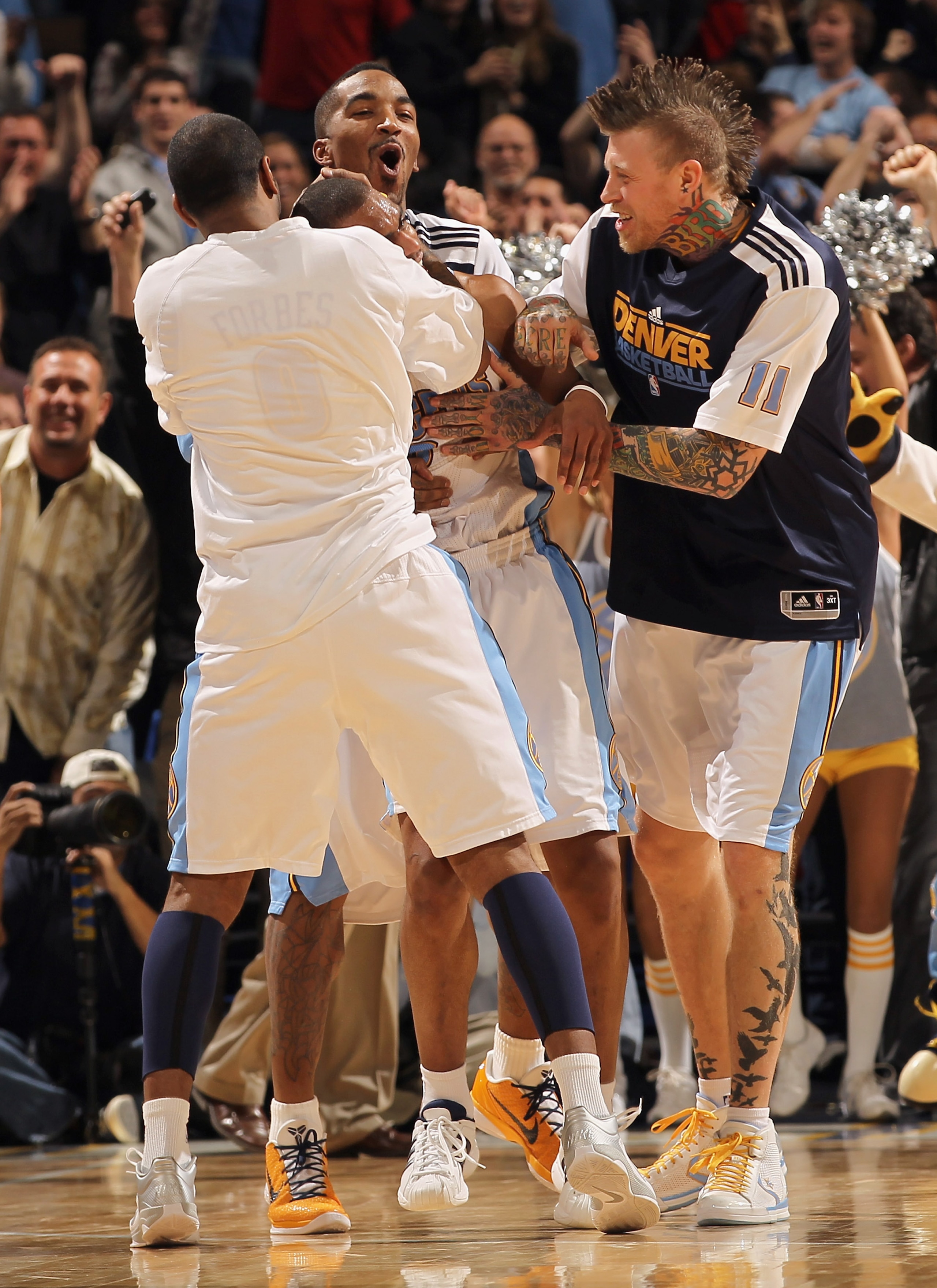 DENVER, CO - FEBRUARY 10:  Arron Afflalo #6 (C) of the Denver Nuggets is congratulated by teammates (L-R) Gary Forbes #0, J.R. Smith #5 and Chris Andersen #11 after he scored the game winning basket with no time remaining against the Dallas Mavericks duri