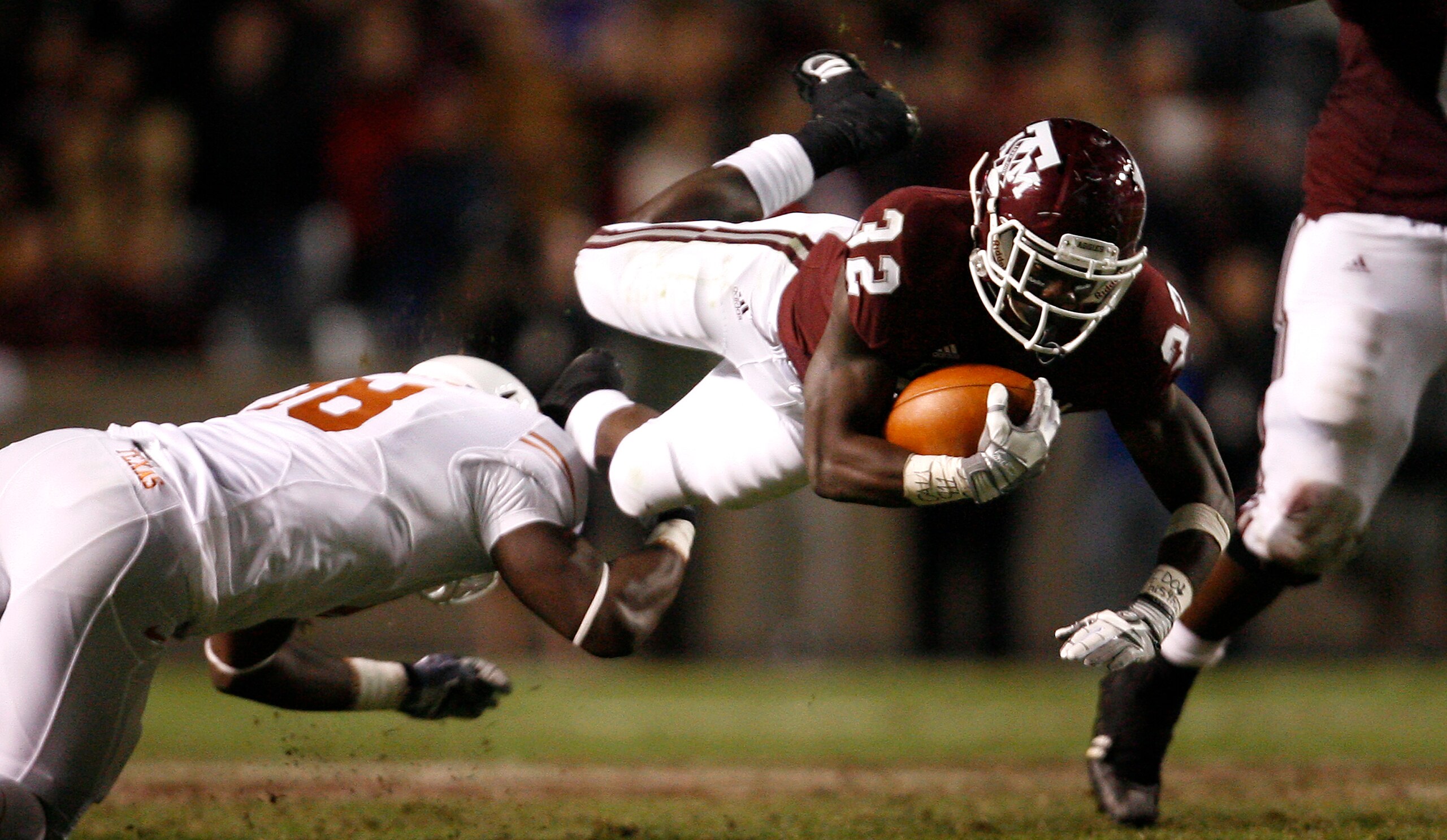 COLLEGE STATION, TX - NOVEMBER 26: Tailback Cyrus Gray #32 of the Texas A&M Aggies is tripped up by a Texas Longhorns defender in the second half at Kyle Field on November 26, 2009 in College Station, Texas. The Longhorns defeated the Aggies 49-39. (Photo COLLEGE STATION, TX - NOVEMBER 26: Tailback Cyrus Gray #32 of the Texas A&M Aggies is tripped up by a Texas Longhorns defender in the second half at Kyle Field on November 26, 2009 in College Station, Texas. The Longhorns defeated the Aggies 49-39. (Photo