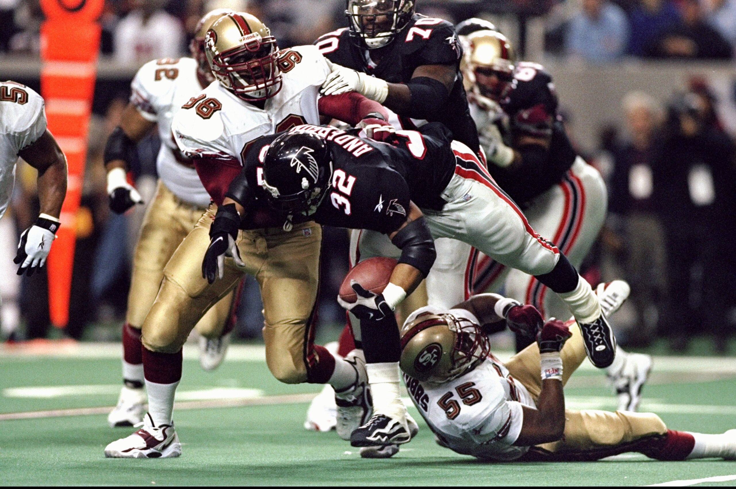 9 Jan 1999: Jamal Anderson #32 of the Atlanta Falcons being tackled by Gabe Wilkins #98 during the NFC Play Off Game against the San Francisco 49ers at the Georgia Dome in Atlanta, Georgia. The Falcons defeated the 49ers 20-18.