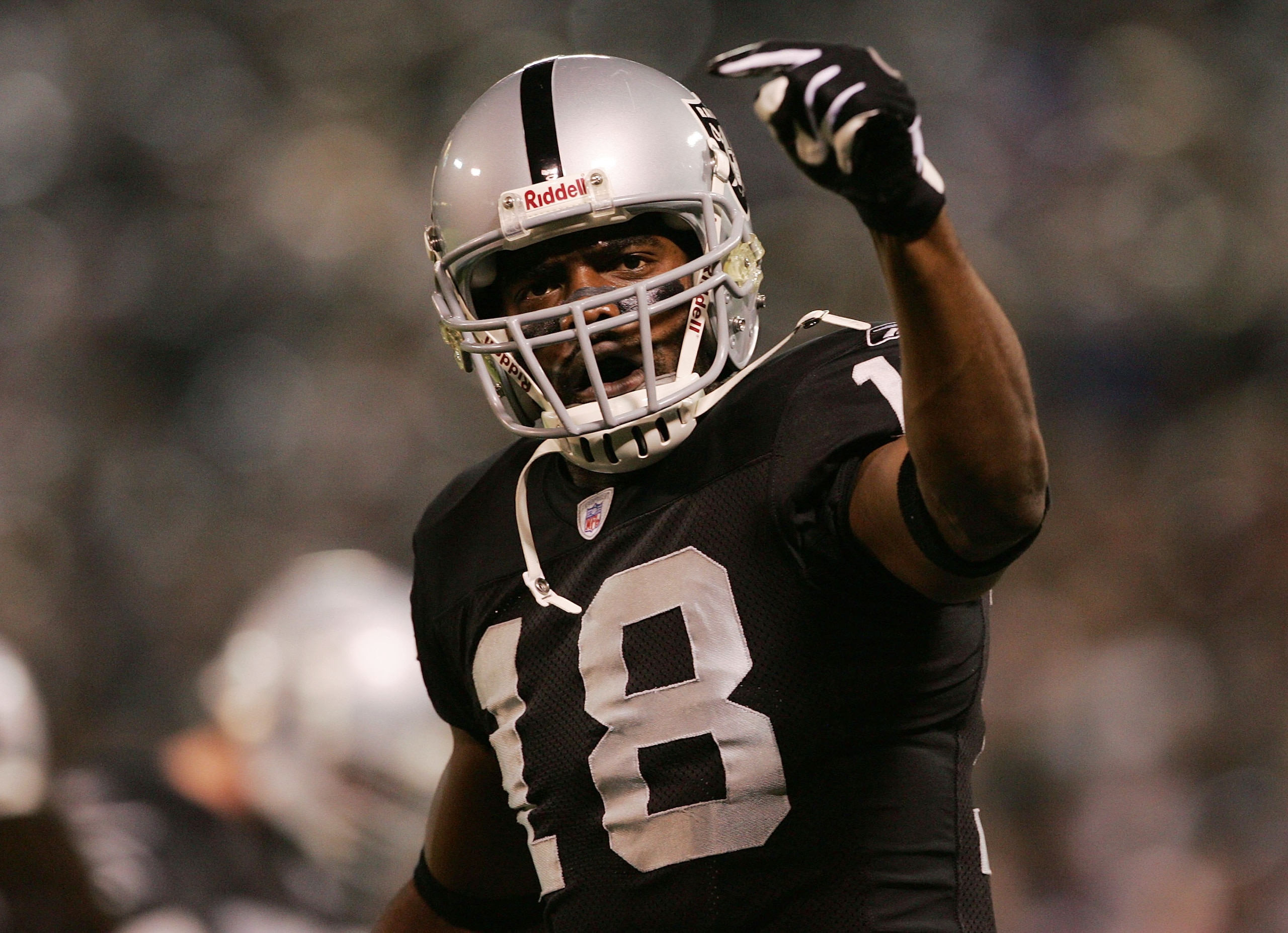 OAKLAND, CA - DECEMBER 31:  Randy Moss #18 of the Oakland Raiders celebrates after scoring a touchdown during the first quarter of the game against the New York Giants on December 31, 2005 at Network Associates Coliseum in Oakland, California.  (Photo by