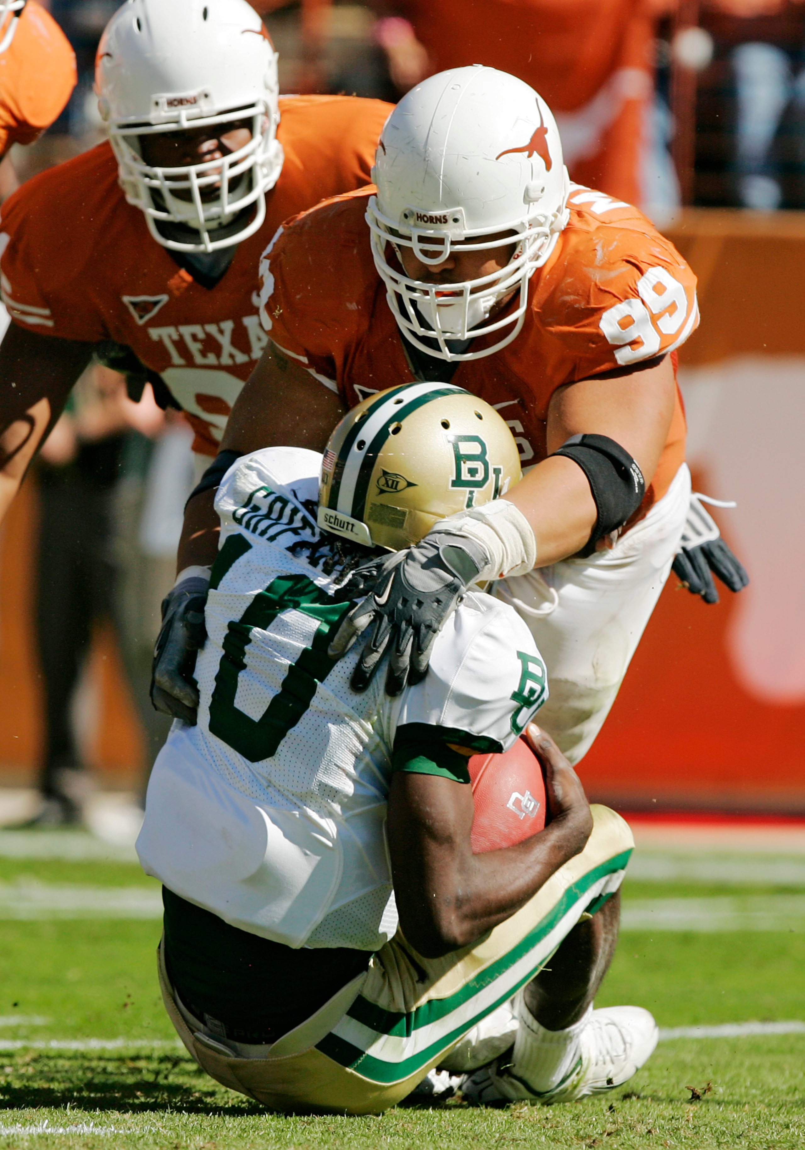 AUSTIN, TX - NOVEMBER 08: Defensive tackle Roy Miller #99 of the Texas Longhorns sacks quarterback Robert Griffin #10 of the Baylor Bears in the second quarter on November 8, 2008 at Darrell K Royal-Texas Memorial Stadium in Austin, Texas. (Photo by Bri AUSTIN, TX - NOVEMBER 08: Defensive tackle Roy Miller #99 of the Texas Longhorns sacks quarterback Robert Griffin #10 of the Baylor Bears in the second quarter on November 8, 2008 at Darrell K Royal-Texas Memorial Stadium in Austin, Texas. (Photo by Bri