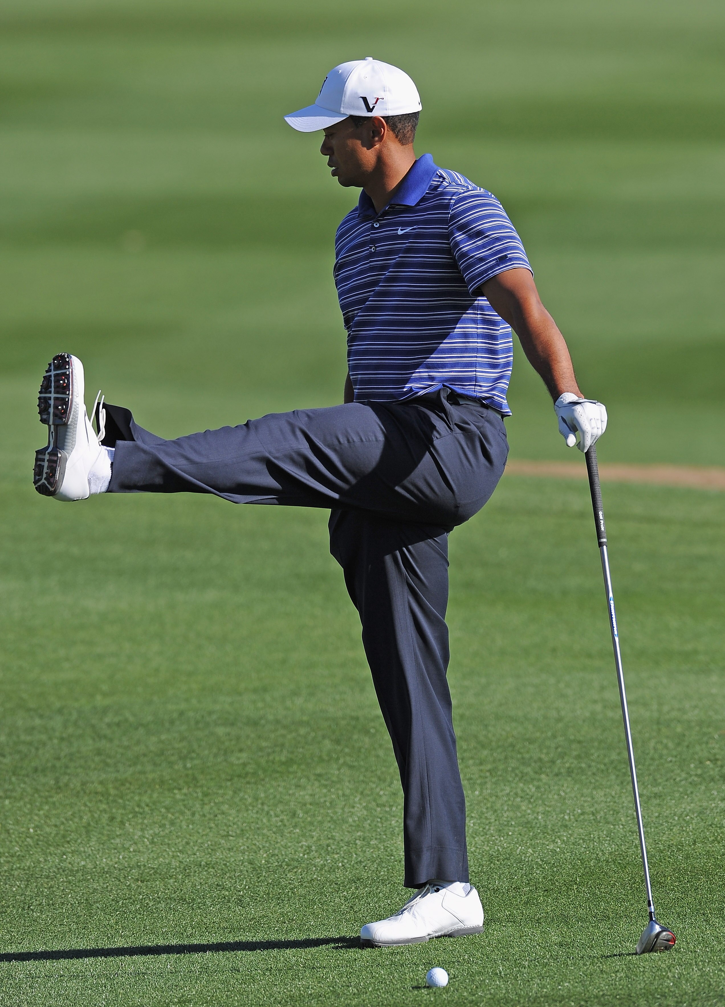 MARANA, AZ - FEBRUARY 22:  Tiger Woods stretches during practice prior to the start of the World Golf Championships-Accenture Match Play Championship held at The Ritz-Carlton Golf Club, Dove Mountain on February 22, 2011 in Marana, Arizona.  (Photo by Stu
