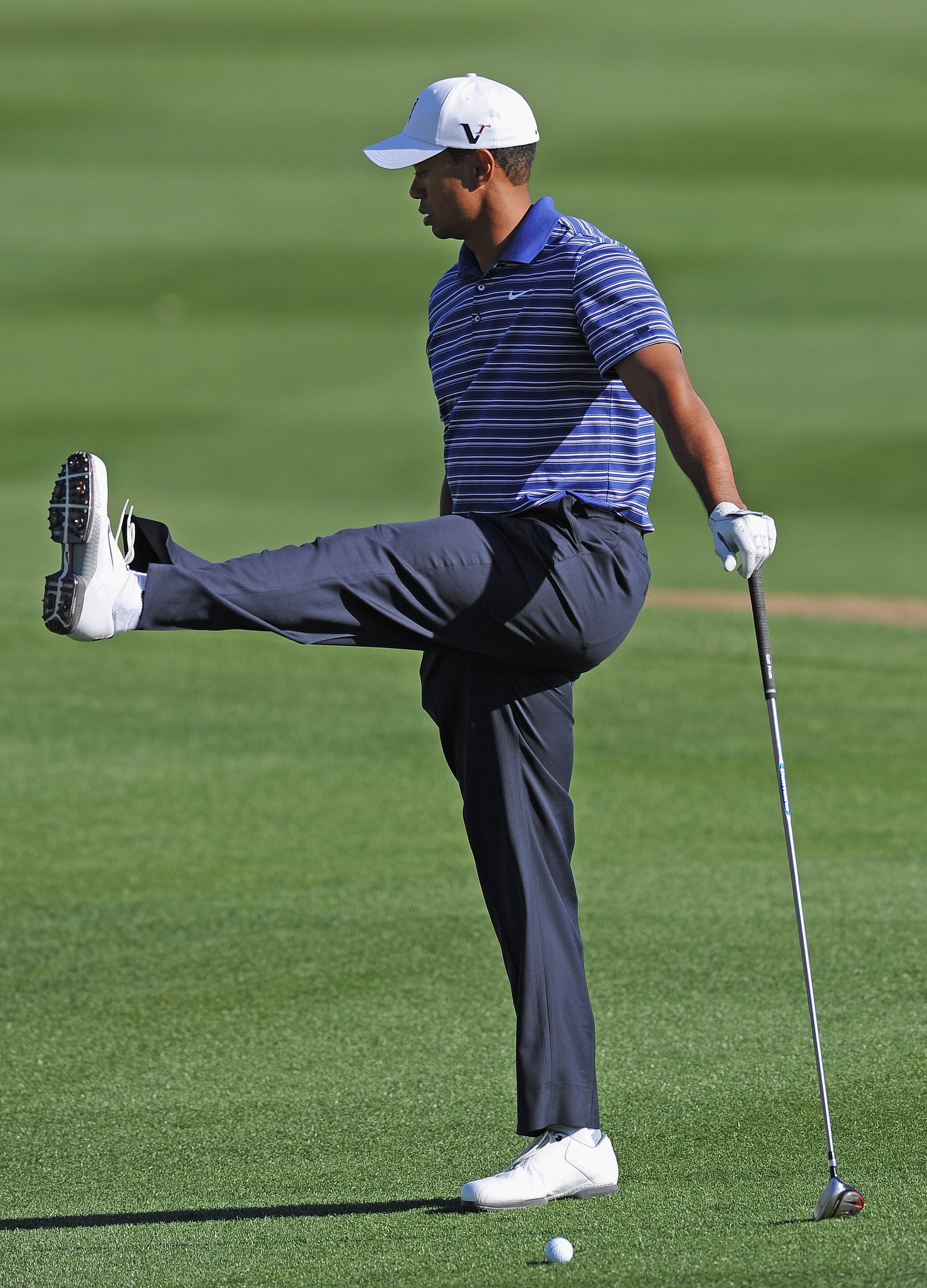 MARANA, AZ - FEBRUARY 22:  Tiger Woods stretches during practice prior to the start of the World Golf Championships-Accenture Match Play Championship held at The Ritz-Carlton Golf Club, Dove Mountain on February 22, 2011 in Marana, Arizona.  (Photo by Stu
