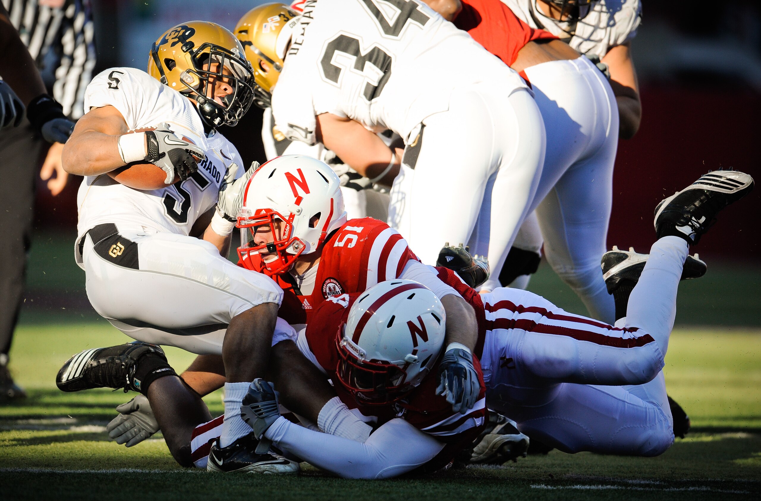 LINCOLN, NE - NOVEMBER 26: Lavonte David #4 and Will Compton #51 of the Nebraska Cornhuskers bring down Rodney Stewart #5 of the Colorado Buffaloes during the first half of their game at Memorial Stadium on November 26, 2010 in Lincoln, Nebraska. (Photo LINCOLN, NE - NOVEMBER 26: Lavonte David #4 and Will Compton #51 of the Nebraska Cornhuskers bring down Rodney Stewart #5 of the Colorado Buffaloes during the first half of their game at Memorial Stadium on November 26, 2010 in Lincoln, Nebraska. (Photo