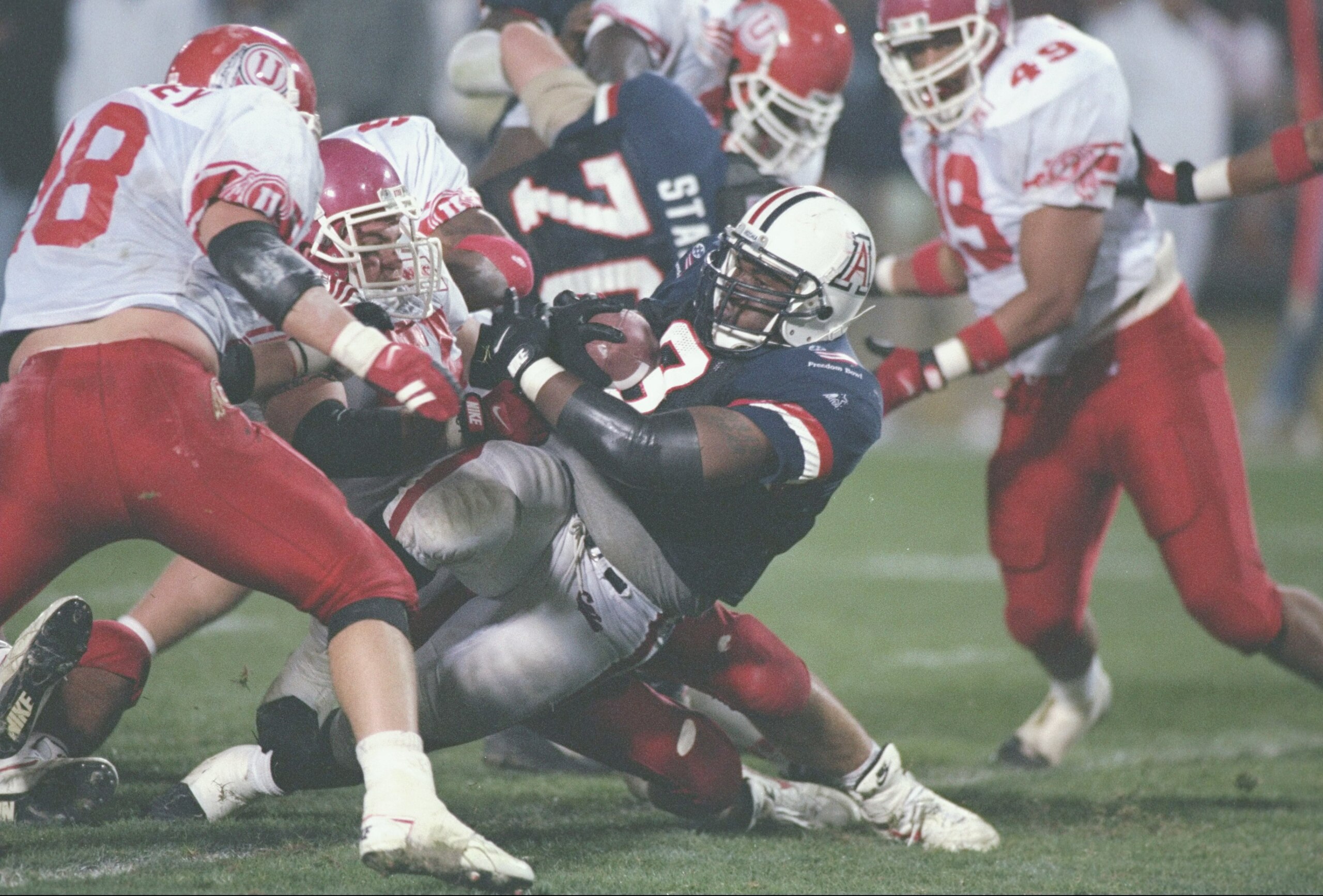 27 Dec 1994: Charles Myles of the Arizona Wildcats is tackled during the Freedom Bowl against the Utah Utes at Anaheim Stadium in Anaheim, California. Utah won the game 16-13. Mandatory Credit: Stephen Dunn /Allsport 27 Dec 1994: Charles Myles of the Arizona Wildcats is tackled during the Freedom Bowl against the Utah Utes at Anaheim Stadium in Anaheim, California. Utah won the game 16-13. Mandatory Credit: Stephen Dunn /Allsport