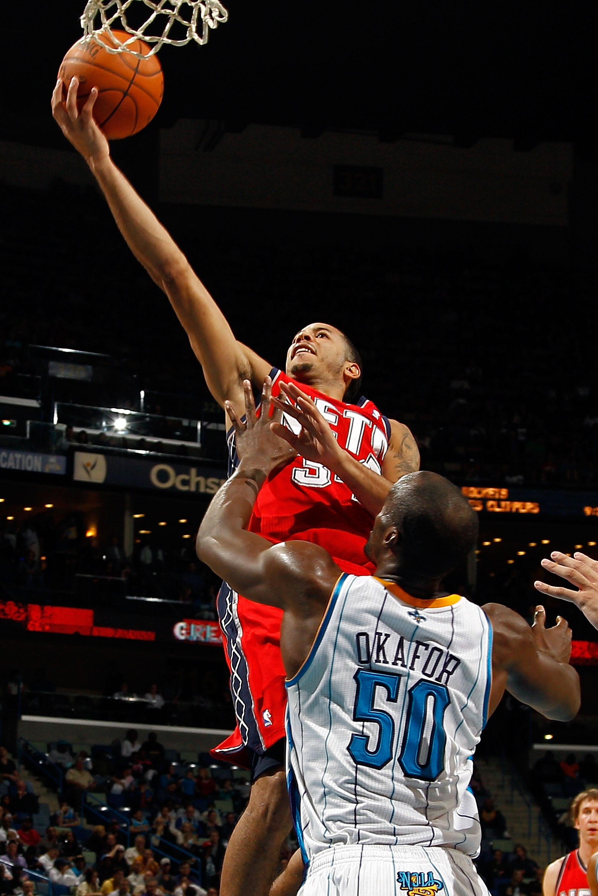 NEW ORLEANS, LA - DECEMBER 22:  Devin Harris #34 of the New Jersey Nets shoots the ball over Emeka Okafor #50 of the New Orleans Hornets at the New Orleans Arena on December 22, 2010 in New Orleans, Louisiana.    The Hornets defeated the Nets 105-91.   NO