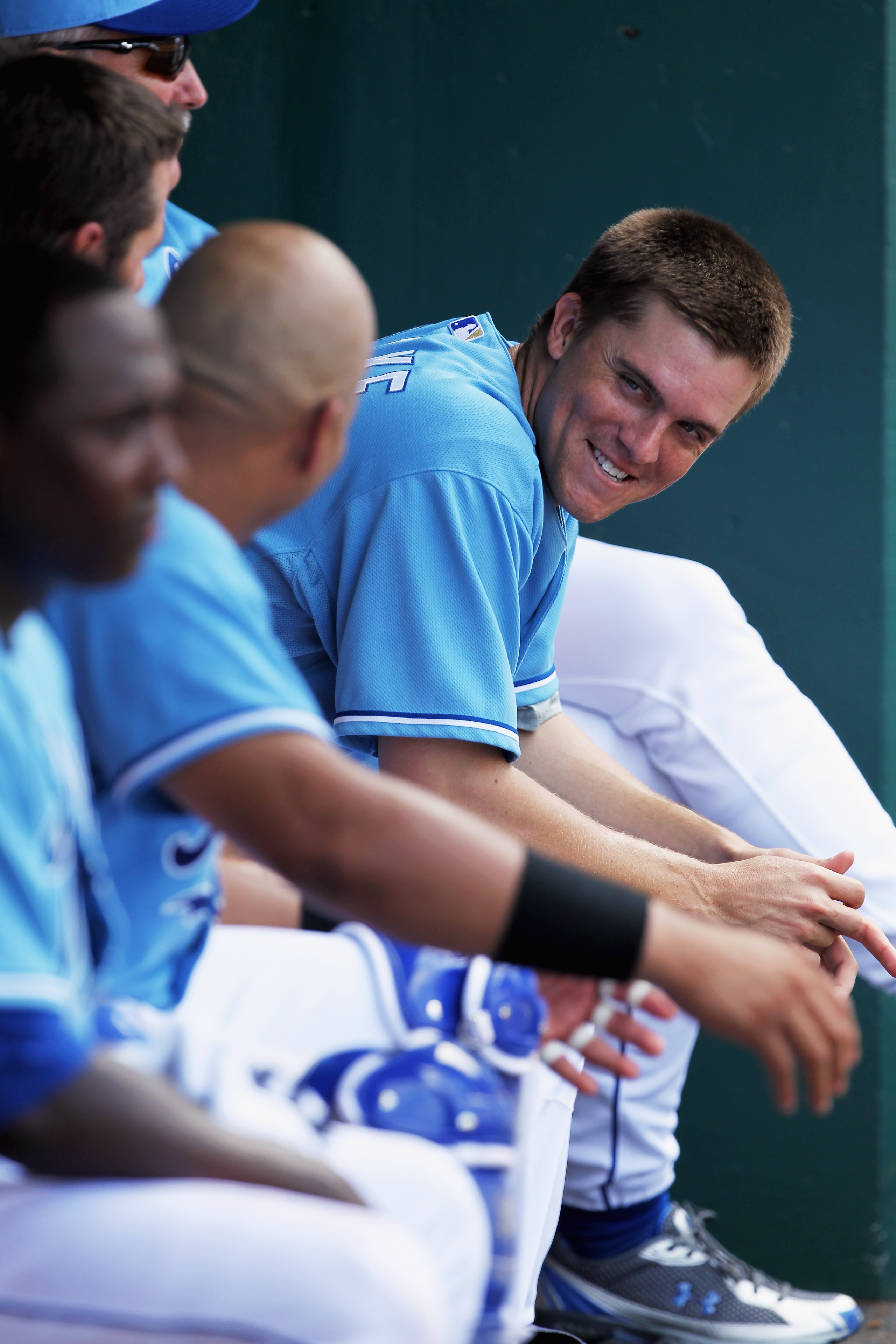 KANSAS CITY, MO - JULY 21:  Starting pitcher Zack Greinke #23 of the Kansas City Royals jokes in the dugout during the game against the Toronto Blue Jays at Kauffman Stadium on July 21, 2010 in Kansas City, Missouri.  (Photo by Jamie Squire/Getty Images)