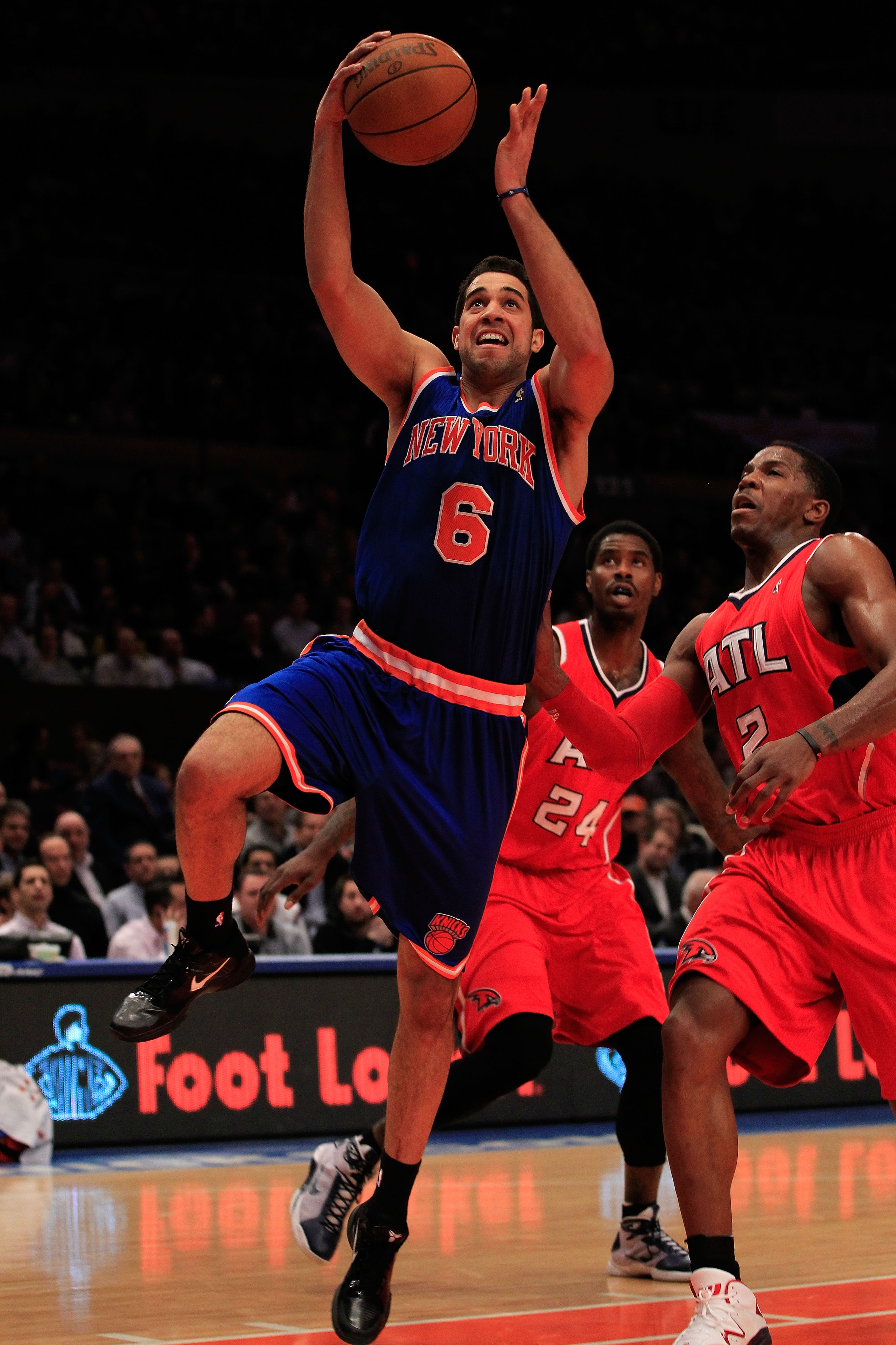 NEW YORK, NY - FEBRUARY 16: Landry Fields #6 of the New York Knicks shoots the ball over Joe Johnson #2 of the Atlanta Hawks at Madison Square Garden on February 16, 2011 in New York City. NOTE TO USER: User expressly acknowledges and agrees that, by down