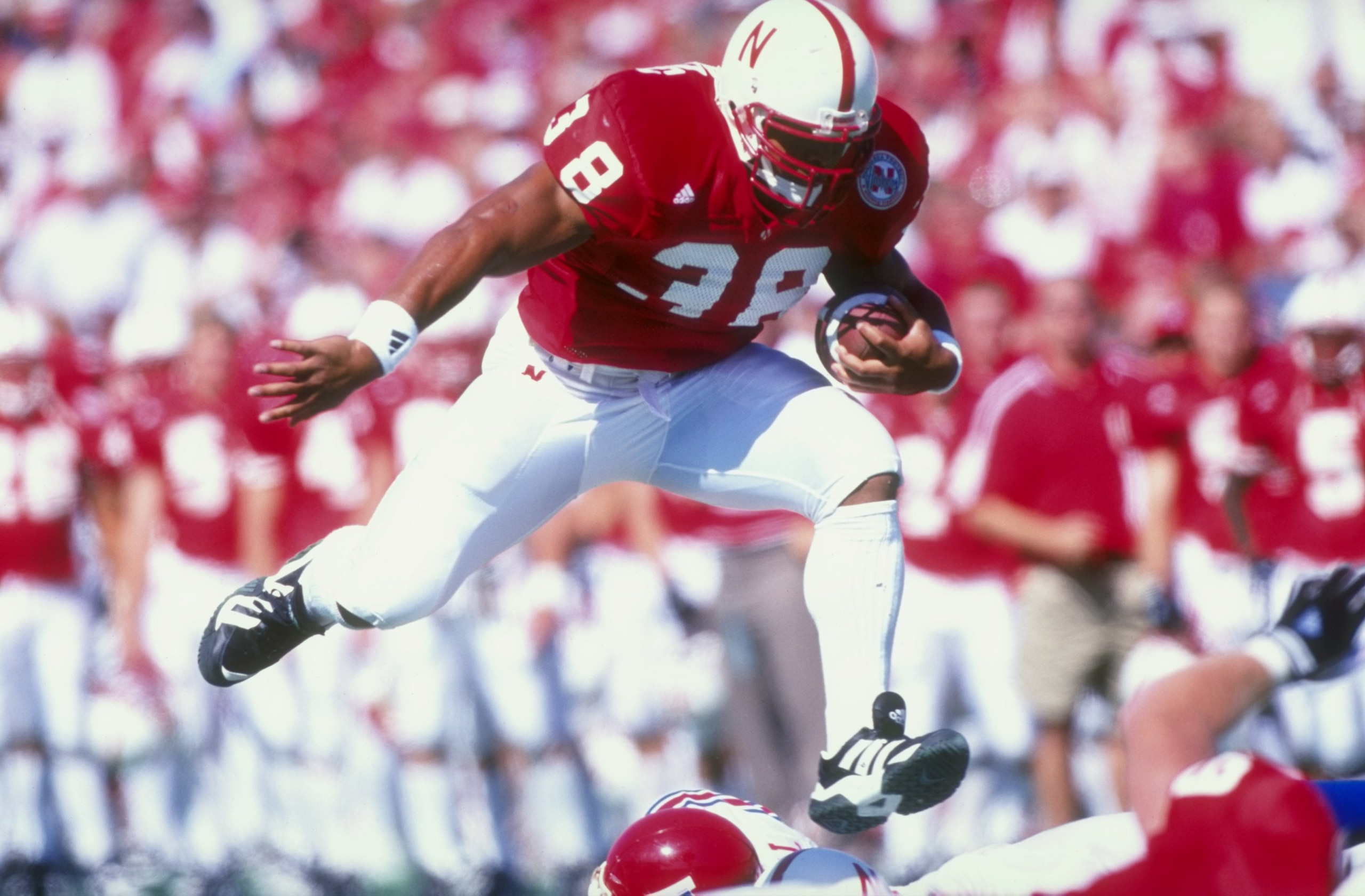 23 Aug 1998: Dan Alexander #38 of the Nebraska Cornhuskers grips the ball as he leaps over players during the Eddie Robison Classic game against the Louisiana Tech Bulldogs at Tom Osborne Field in Lincoln, Nebraska. Nebraska defeated Louisiana Tech 56-2 23 Aug 1998: Dan Alexander #38 of the Nebraska Cornhuskers grips the ball as he leaps over players during the Eddie Robison Classic game against the Louisiana Tech Bulldogs at Tom Osborne Field in Lincoln, Nebraska. Nebraska defeated Louisiana Tech 56-2