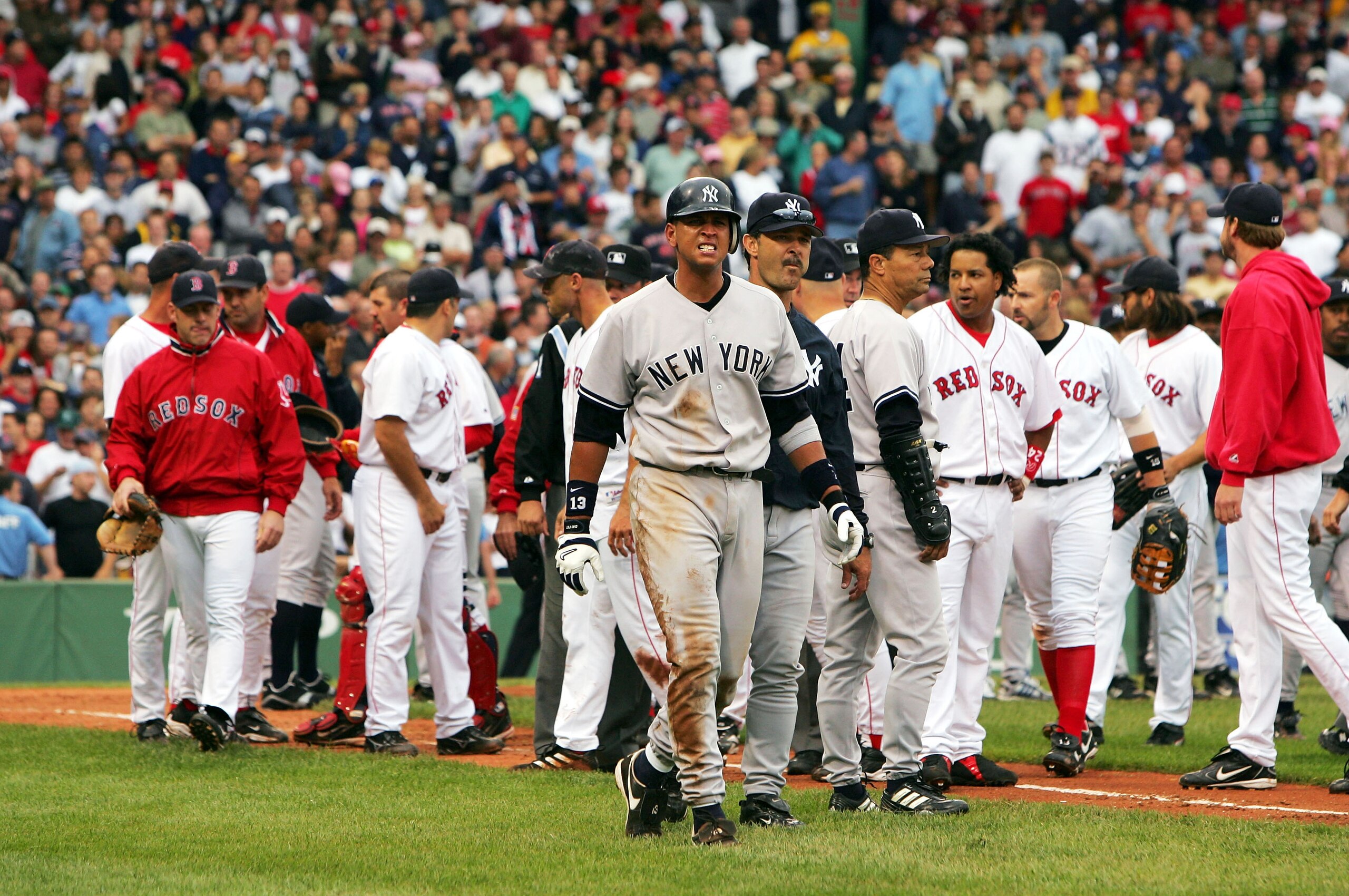 BOSTON - JULY 24:  Alex Rodriguez #13 of the New York Yankees walks to first base with hitting coach Don Mattingly #23 after a fight with Jason Varitek #33 of the Boston Red Sox in the third inning after Rodriguez was hit by a pitch by pitcher Bronson Arr