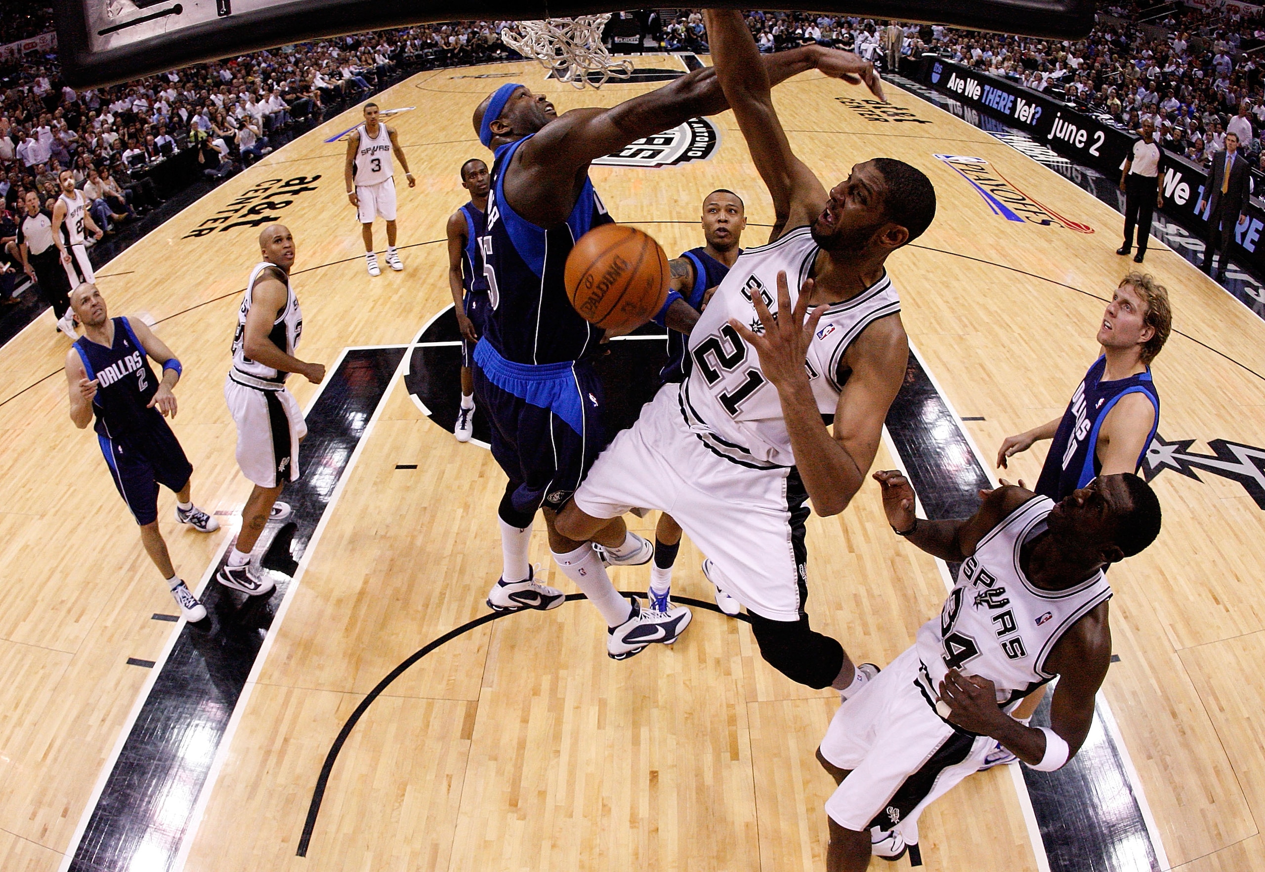 SAN ANTONIO - APRIL 29:  Forward Tim Duncan #21 of the San Antonio Spurs slams the ball against Erick Dampier #25 of the Dallas Mavericks in Game Six of the Western Conference Quarterfinals during the 2010 NBA Playoffs at AT&T Center on April 29, 2010 in
