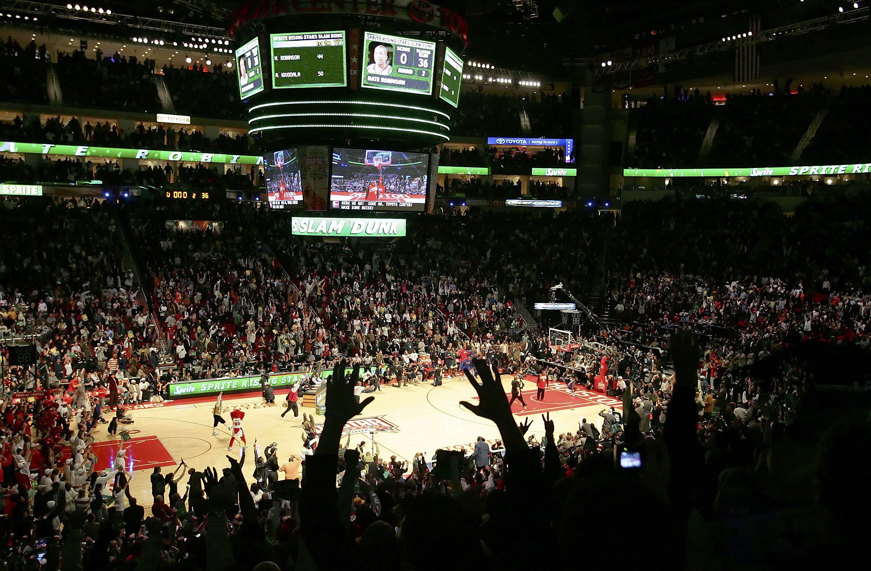 HOUSTON - FEBRUARY 18:  The crowd reacts to the winning dunk by Nate Robinson #4 of the New York Knicks over former NBA player Spud Webb in the Sprite Rising Stars Slam Dunk competition during NBA All-Star Weekend at the Toyota Center on February 18, 2006