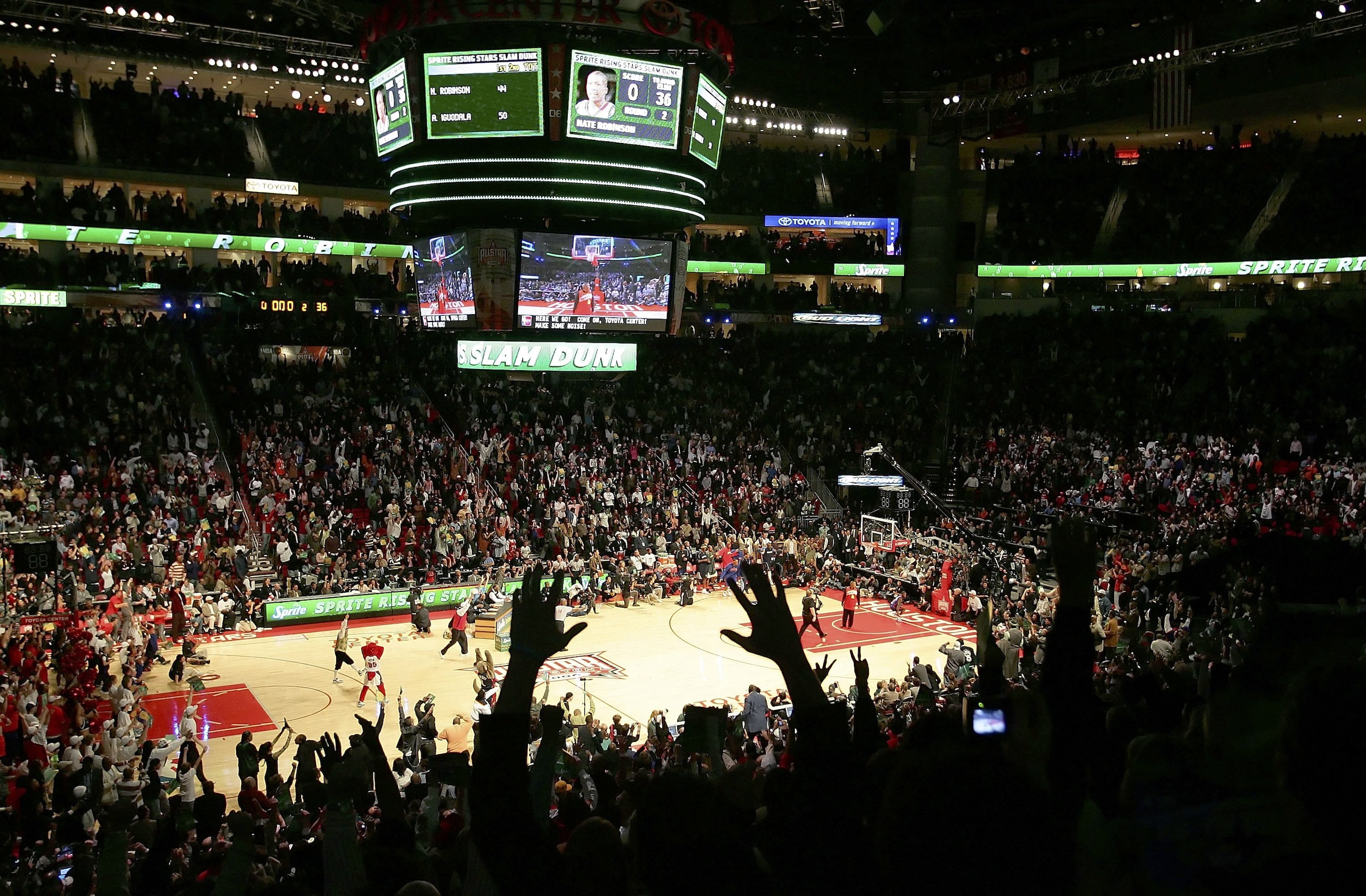 HOUSTON - FEBRUARY 18:  The crowd reacts to the winning dunk by Nate Robinson #4 of the New York Knicks over former NBA player Spud Webb in the Sprite Rising Stars Slam Dunk competition during NBA All-Star Weekend at the Toyota Center on February 18, 2006