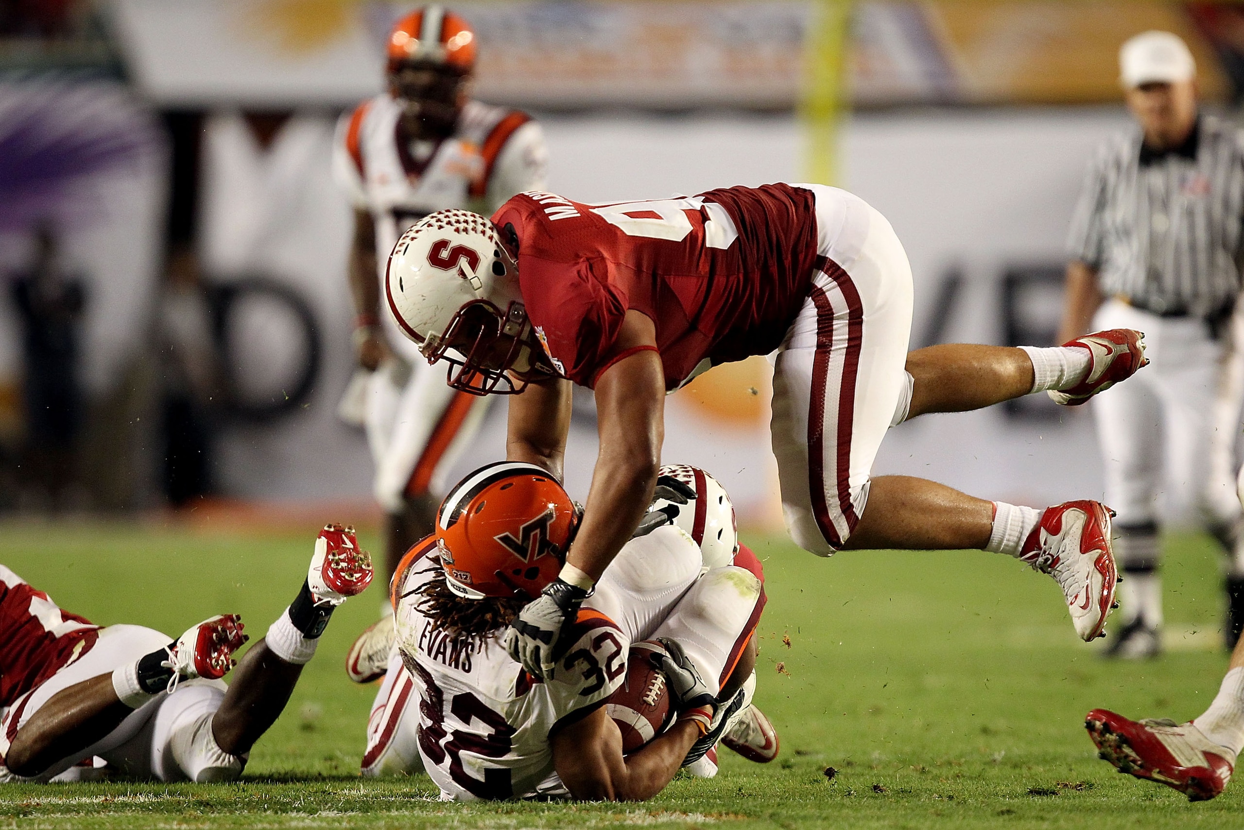 MIAMI, FL - JANUARY 03: Matthew Masifilo #98 of the Stanford Cardinal tackles Darren Evans #32 of the Virginia Tech Hokies during the 2011 Discover Orange Bowl at Sun Life Stadium on January 3, 2011 in Miami, Florida. Stanford won 40-12. (Photo by Streete