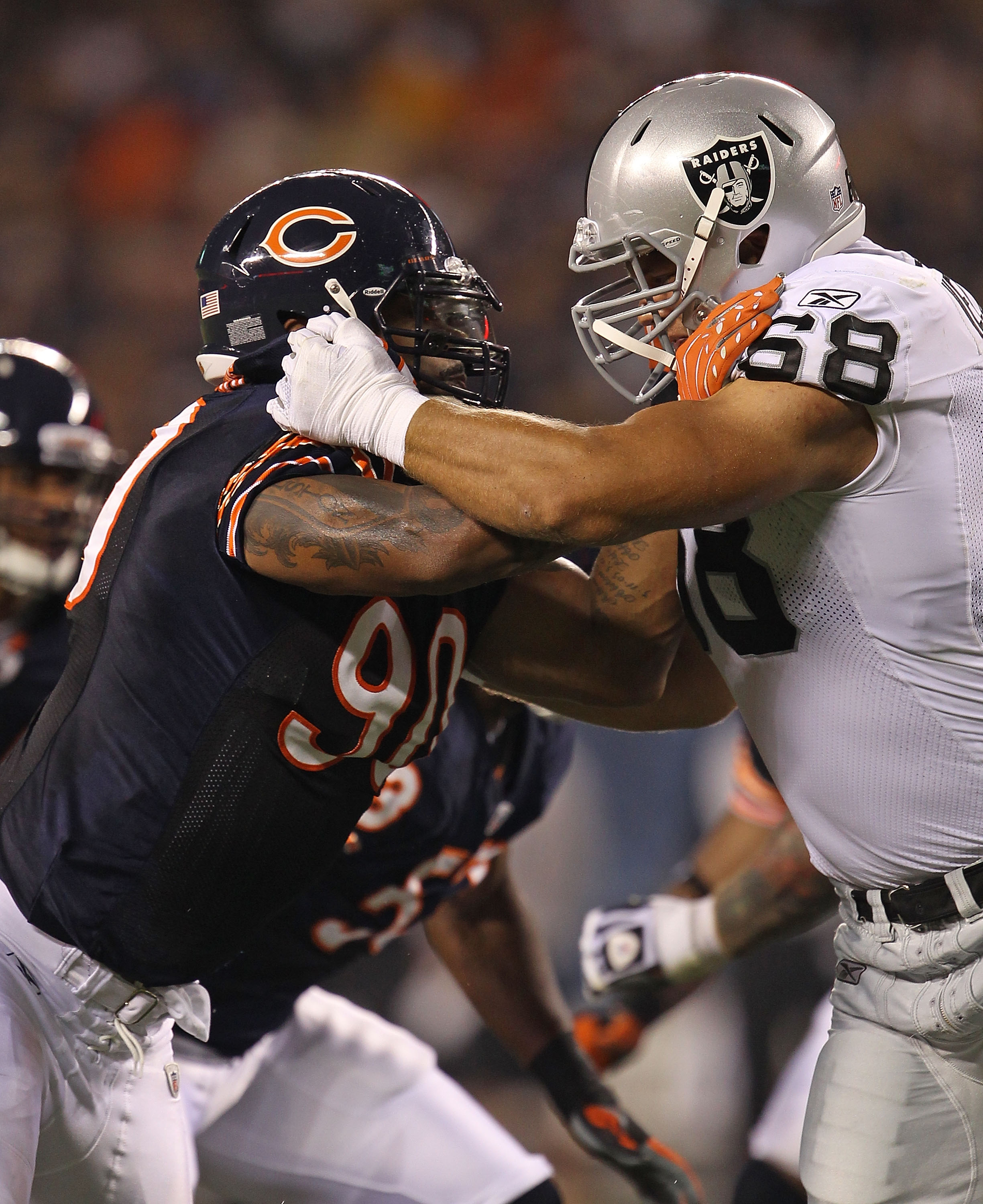 CHICAGO - AUGUST 21: Julius Peppers #90 of the Chicago Bears rushes against Jared Veldheer #68 of the Oakland Raiders during a preseason game at Soldier Field on August 21, 2010 in Chicago, Illinois. The Radiers defeated the Bears 32-17. (Photo by Jonatha