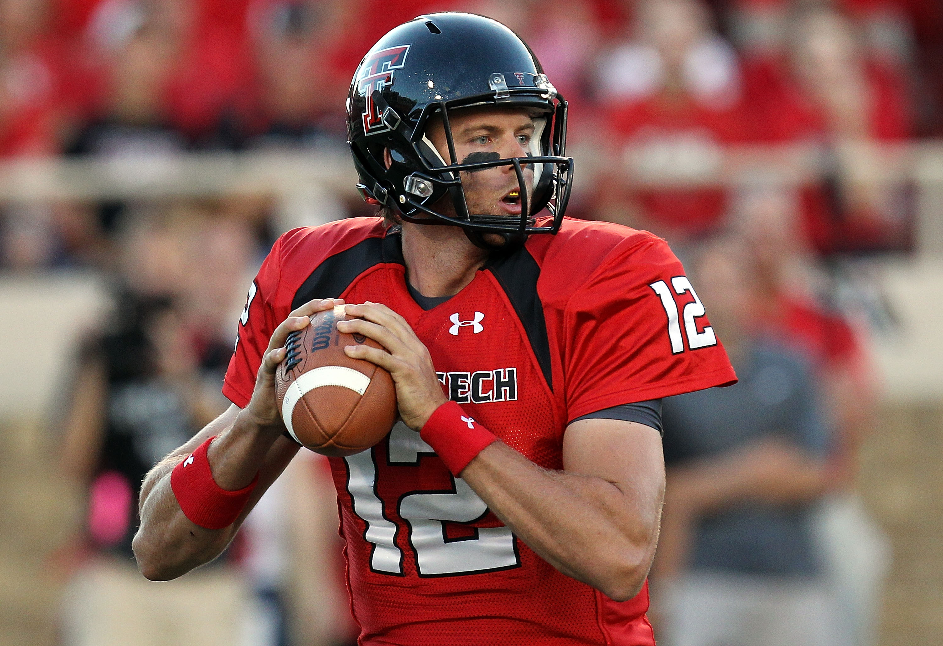 LUBBOCK, TX - SEPTEMBER 18:  Quarterback Taylor Potts #12 of the Texas Tech Red Raiders drops back to pass against the Texas Longhorns at Jones AT&T Stadium on September 18, 2010 in Lubbock, Texas.  (Photo by Ronald Martinez/Getty Images)