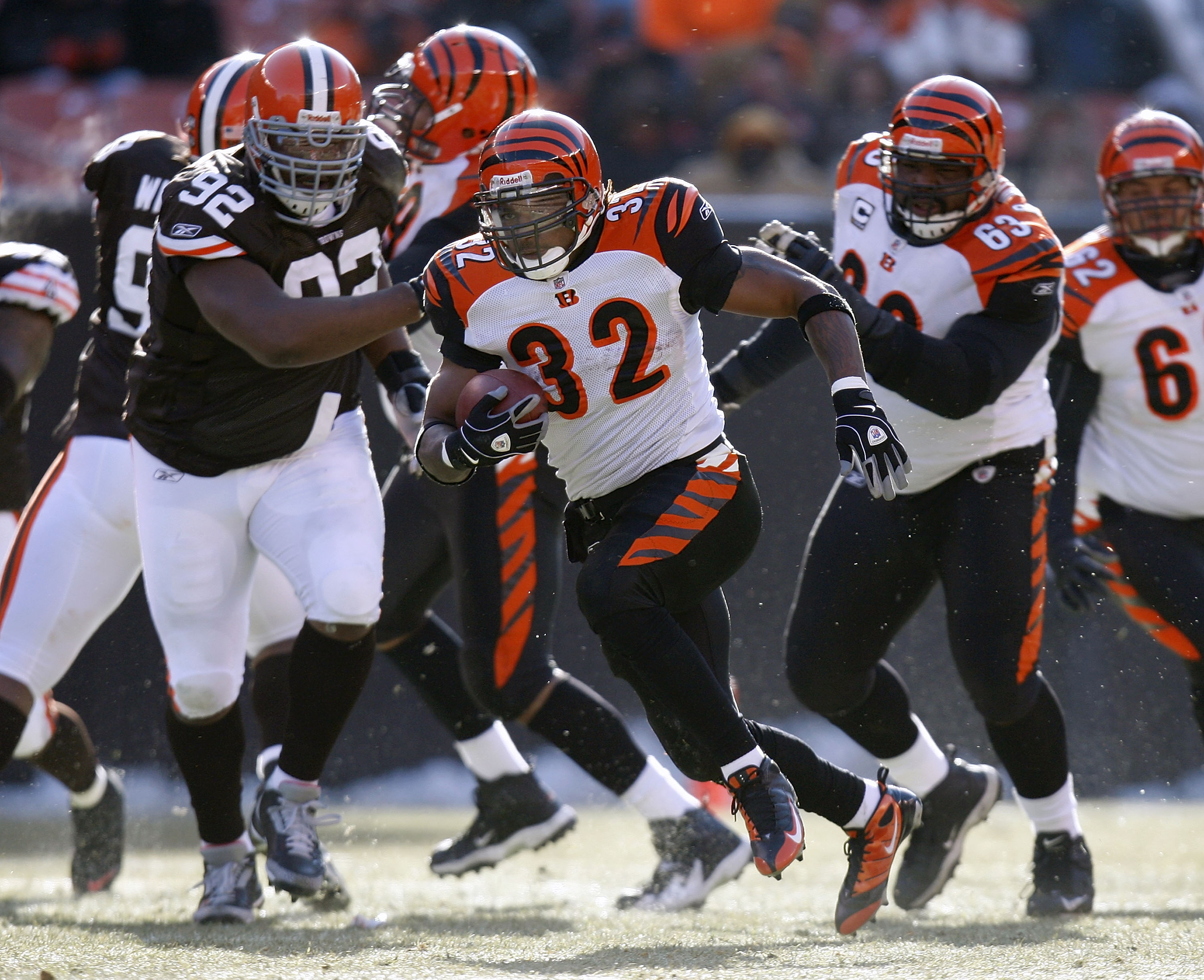 CLEVELAND - DECEMBER 21:  Cedric Benson #32 of the Cincinnati Bengals gets into the open field in front of Shaun Rogers #92 of the Cleveland Browns during a first quarter run at Cleveland Browns Stadium December 21, 2008 in Cleveland, Ohio. Cincinnati won