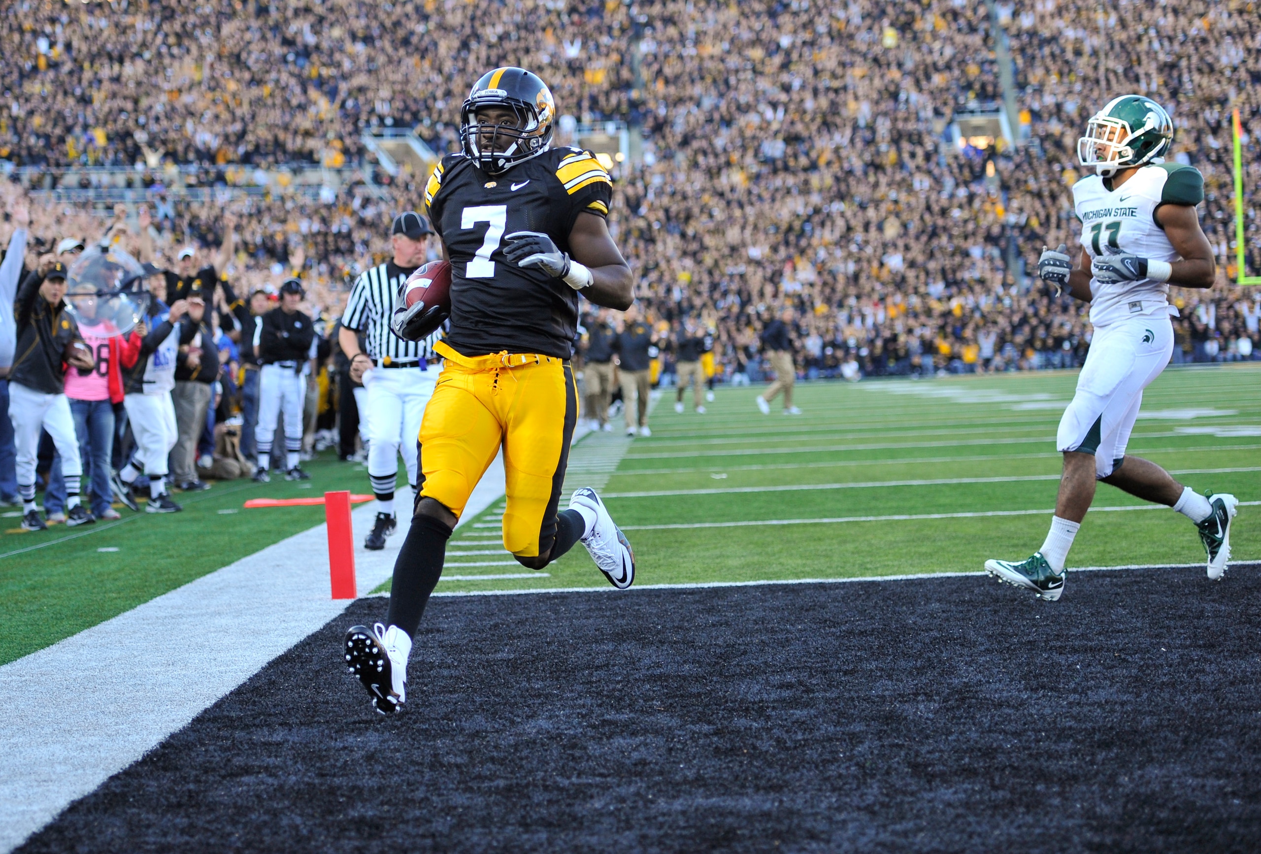 IOWA CITY, IA - OCTOBER 30: Wide receiver Marvin McNutt Jr. #7 of the University of Iowa Hawkeyes runs into the end zone for a touch down as safety Marcus Hyde #11 of the Michigan State Spartans defends during the second half of play at Kinnick Stadium on
