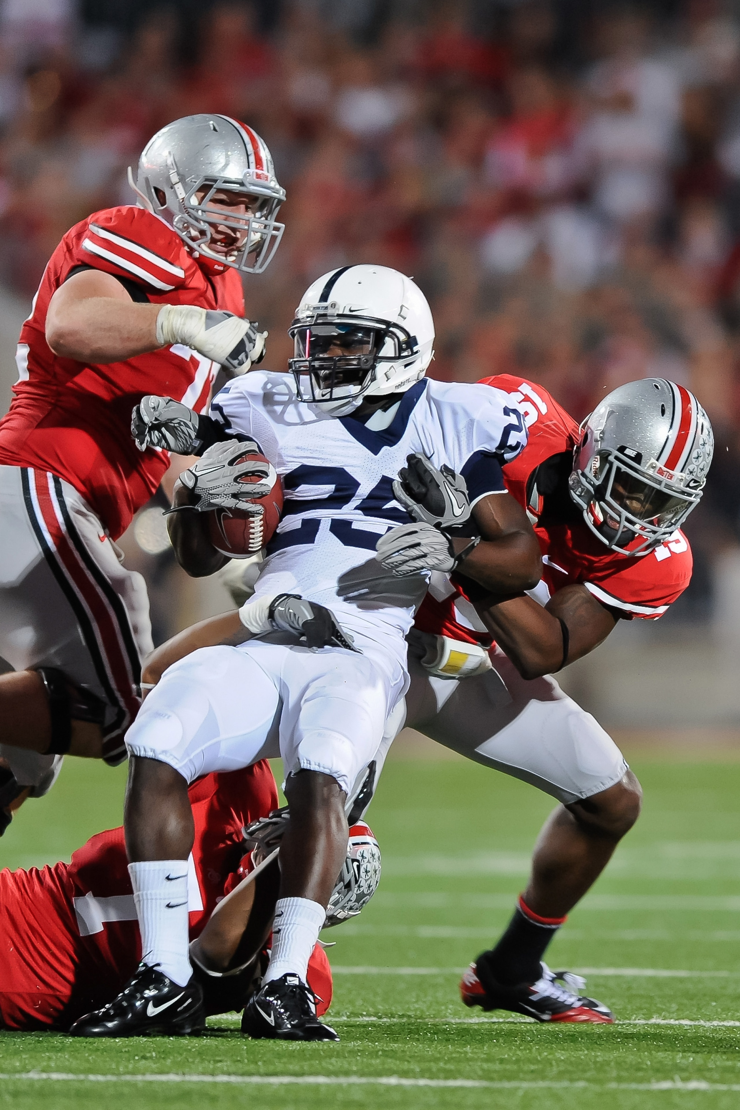 COLUMBUS, OH - NOVEMBER 13:  Silas Redd #25 of the Penn State Nittany LIons is tackled by Jermale Hines #7, Orhian Johnson #19 and Dexter Larimore #72, all of the Ohio State Buckeyes at Ohio Stadium on November 13, 2010 in Columbus, Ohio.  (Photo by Jamie
