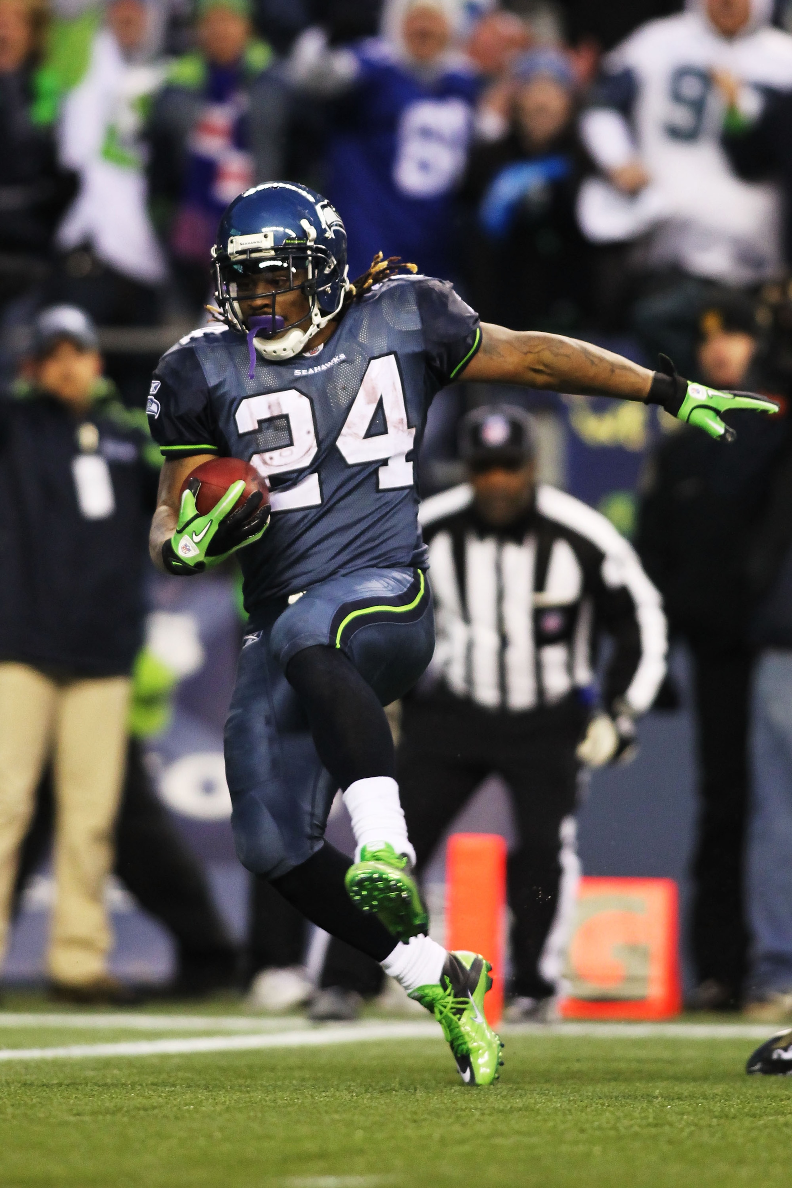 SEATTLE, WA - JANUARY 08:  Running back Marshawn Lynch #24 of the Seattle Seahawks runs for a 67-yard touchdown run in the fourth quarter against the New Orleans Saints during the 2011 NFC wild-card playoff game at Qwest Field on January 8, 2011 in Seattl