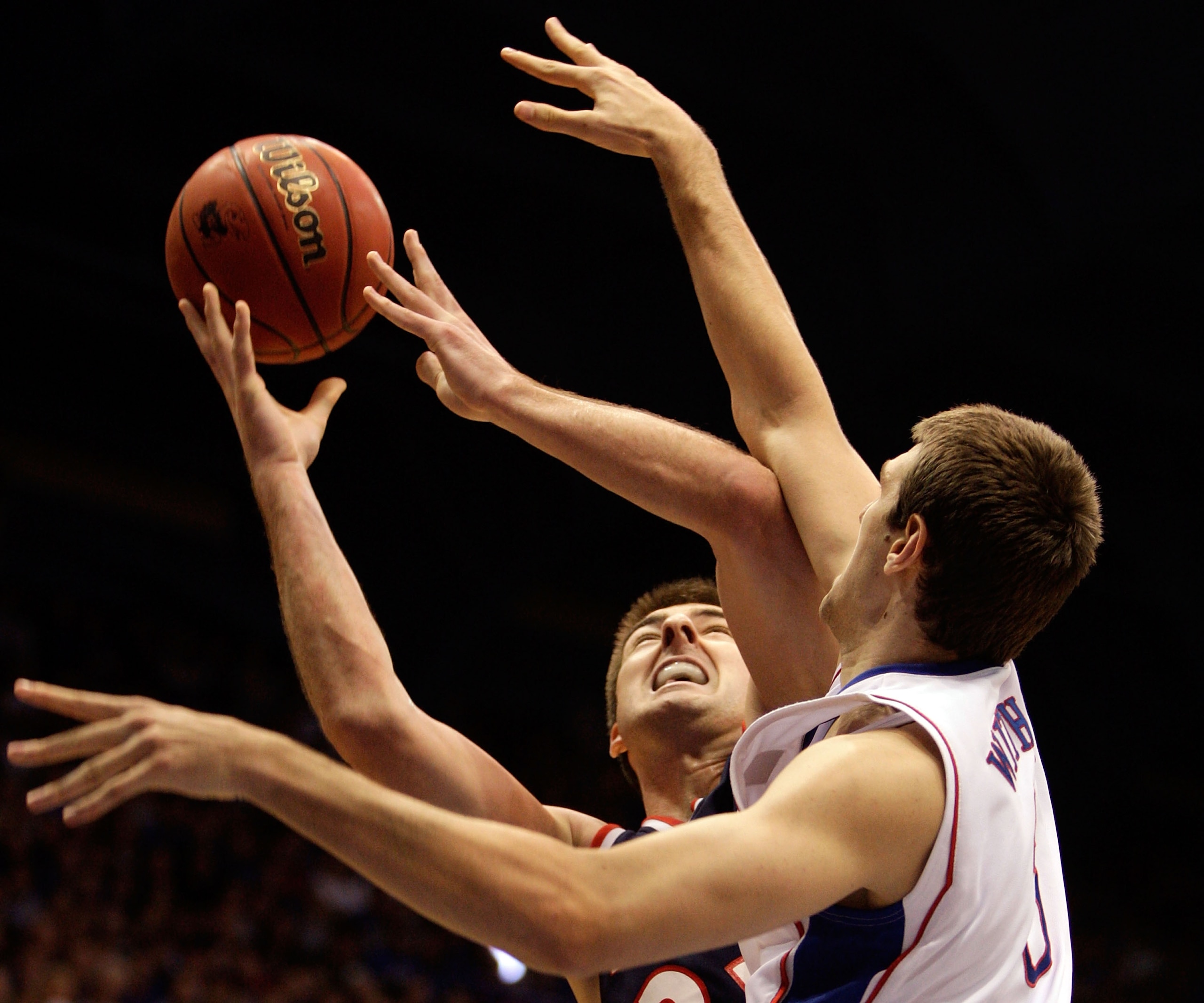 LAWRENCE, KS - DECEMBER 29:  Scott Saunders #23 of the Belmont Bruins is fouled by Jeff Withey #5 of the Kansas Jayhawks during the game on December 29, 2009 at Allen Fieldhouse in Lawrence, Kansas.  (Photo by Jamie Squire/Getty Images)