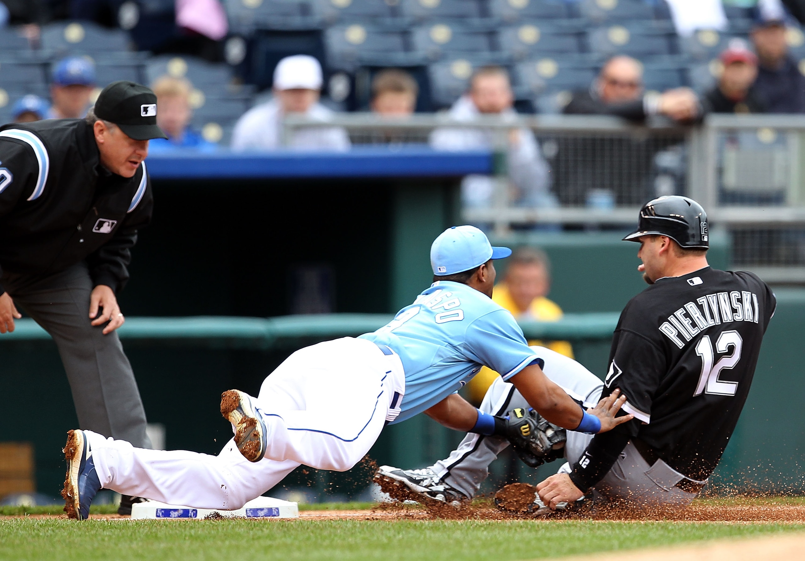 KANSAS CITY, MO - MAY 16:  A.J. Pierzynski #12 of the Chicago White Sox is tagged out while sliding into third by third-baseman Alberto Callaspo #13 of the Kansas City Royals during the game on May 16, 2010 at Kauffman Stadium in Kansas City, Missouri.  (