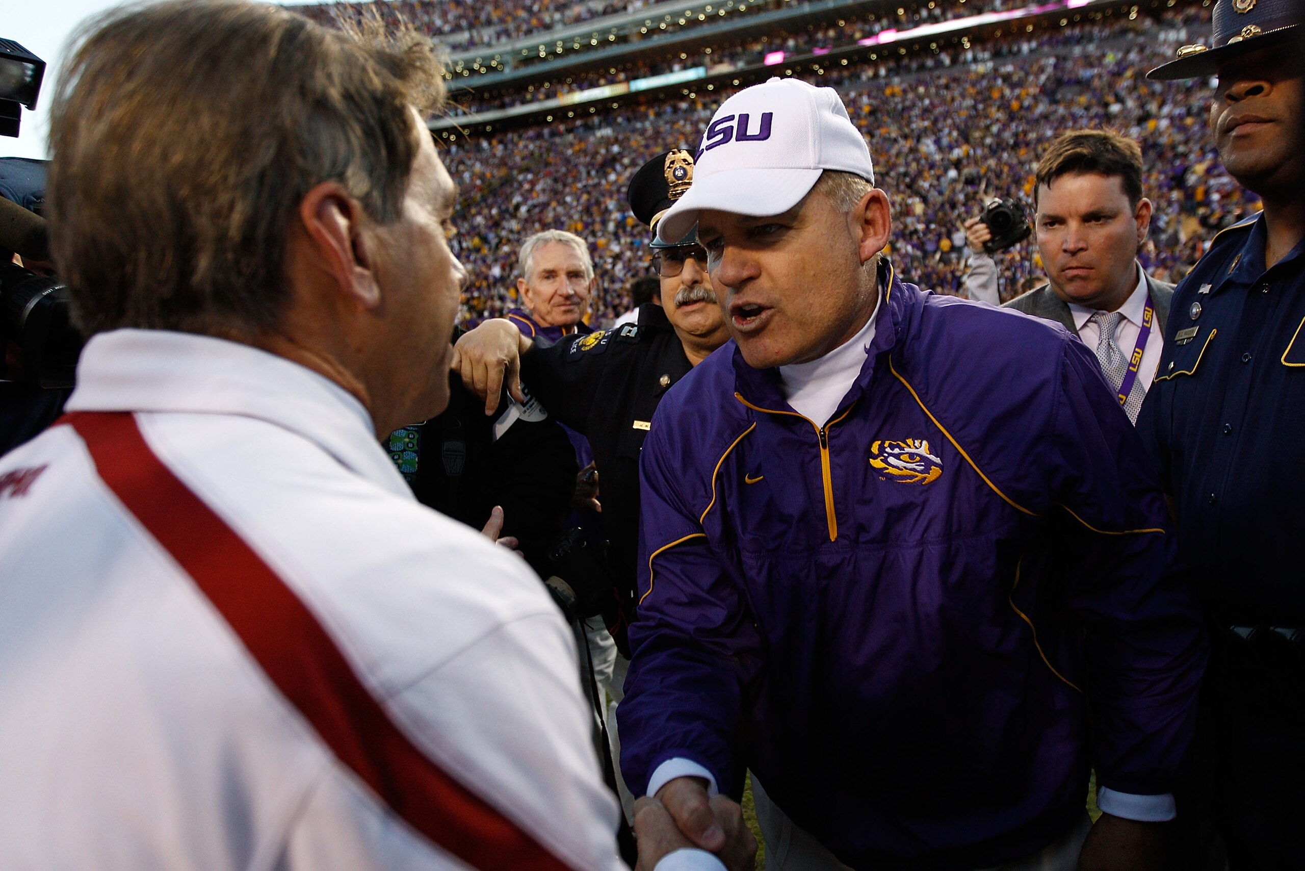 BATON ROUGE, LA - NOVEMBER 06: Head coach Les Miles of the Louisiana State University Tigers is congratulated by Nick Saban of the Alabama Crimson Tide at Tiger Stadium on November 6, 2010 in Baton Rouge, Louisiana. The Tigers defeated the Crimson Tide 2 BATON ROUGE, LA - NOVEMBER 06: Head coach Les Miles of the Louisiana State University Tigers is congratulated by Nick Saban of the Alabama Crimson Tide at Tiger Stadium on November 6, 2010 in Baton Rouge, Louisiana. The Tigers defeated the Crimson Tide 2