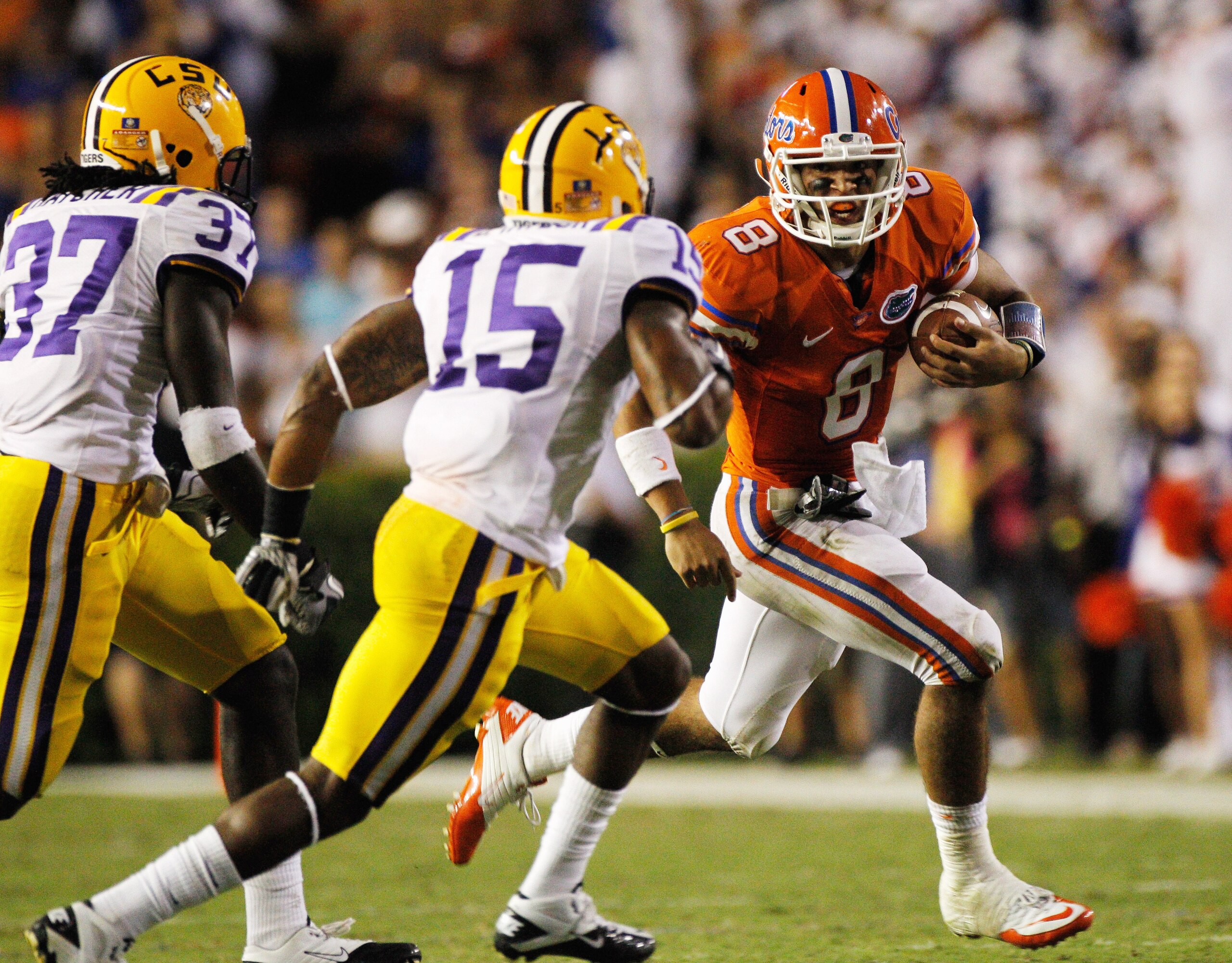 GAINESVILLE, FL - OCTOBER 09: Karnell Hatcher #37 and Brandon Taylor #15 of the Louisiana State University Tigers attempt to tackle Trey Burton #8 of the Florida Gators during the game at Ben Hill Griffin Stadium on October 9, 2010 in Gainesville, Flori GAINESVILLE, FL - OCTOBER 09: Karnell Hatcher #37 and Brandon Taylor #15 of the Louisiana State University Tigers attempt to tackle Trey Burton #8 of the Florida Gators during the game at Ben Hill Griffin Stadium on October 9, 2010 in Gainesville, Flori
