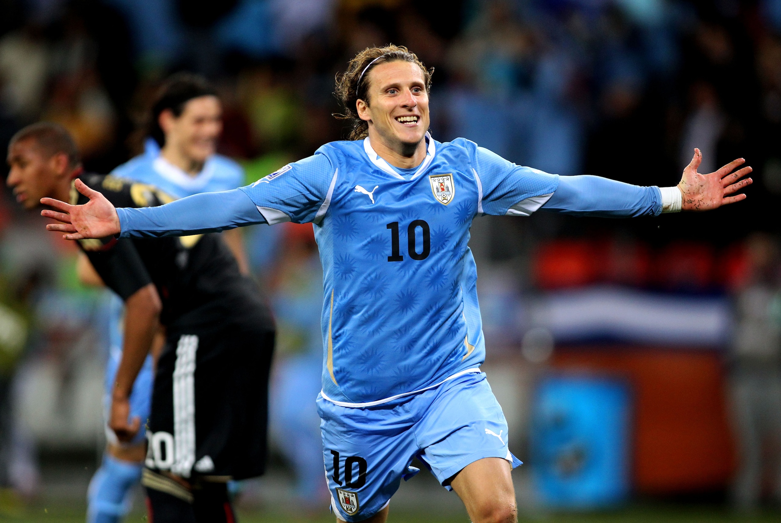 PORT ELIZABETH, SOUTH AFRICA - JULY 10: Diego Forlan of Uruguay celebrates scoring his team's second goal during the 2010 FIFA World Cup South Africa Third Place Play-off match between Uruguay and Germany at The Nelson Mandela Bay Stadium on July 10, 201 PORT ELIZABETH, SOUTH AFRICA - JULY 10: Diego Forlan of Uruguay celebrates scoring his team's second goal during the 2010 FIFA World Cup South Africa Third Place Play-off match between Uruguay and Germany at The Nelson Mandela Bay Stadium on July 10, 201