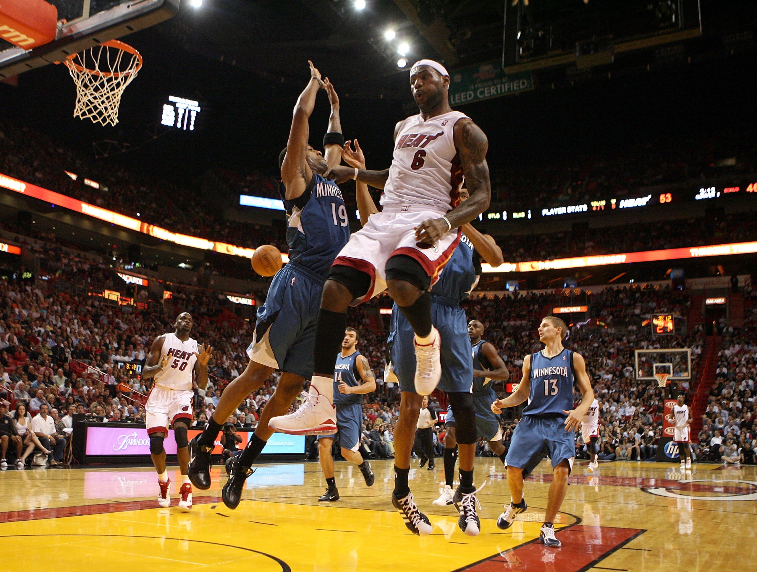 MIAMI - NOVEMBER 02:  Forward LeBron James #6 of the Miami Heat passes around guard Wayne Ellington #19 of the Minnesota Timberwolves at American Airlines Arena on November 2, 2010 in Miami, Florida. NOTE TO USER: User expressly acknowledges and agrees th