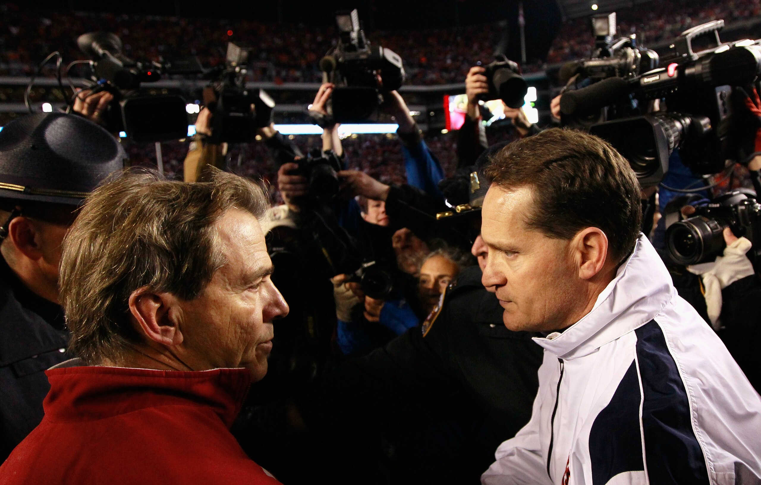 TUSCALOOSA, AL - NOVEMBER 26: Head coach Gene Chizik of the Auburn Tigers is congratulated by head coach Nick Saban of the Alabama Crimson Tide after the Tigers 28-27 win at Bryant-Denny Stadium on November 26, 2010 in Tuscaloosa, Alabama. (Photo by Kev TUSCALOOSA, AL - NOVEMBER 26: Head coach Gene Chizik of the Auburn Tigers is congratulated by head coach Nick Saban of the Alabama Crimson Tide after the Tigers 28-27 win at Bryant-Denny Stadium on November 26, 2010 in Tuscaloosa, Alabama. (Photo by Kev