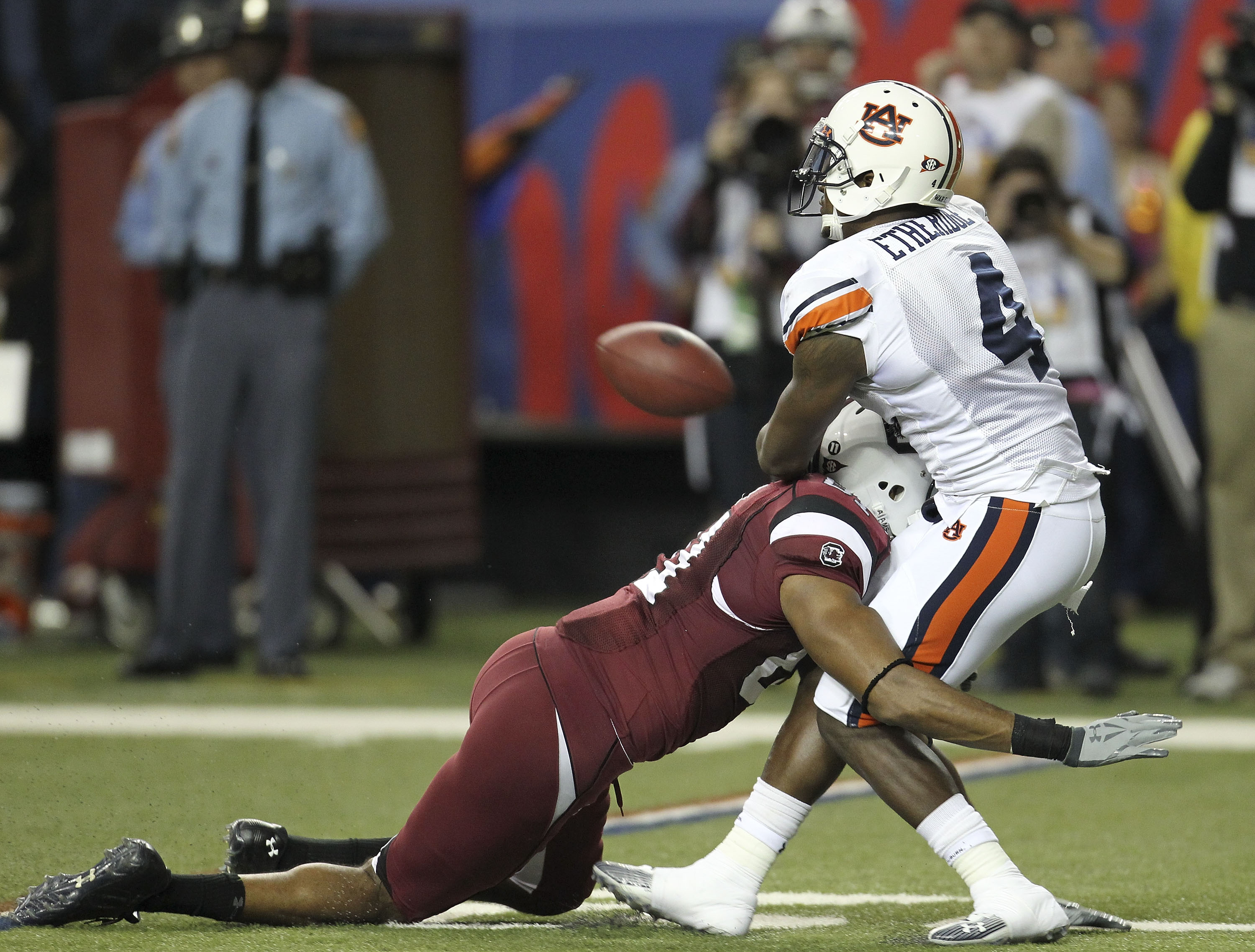 ATLANTA - DECEMBER 4:  Safety Zac Etheridge #4 of the Auburn Tigers commits a pass interference penalty on wide receiver Tori Gurley #81 of the South Carolina Gamecocks at the end of the first half during the 2010 SEC Championship at Georgia Dome on Decem