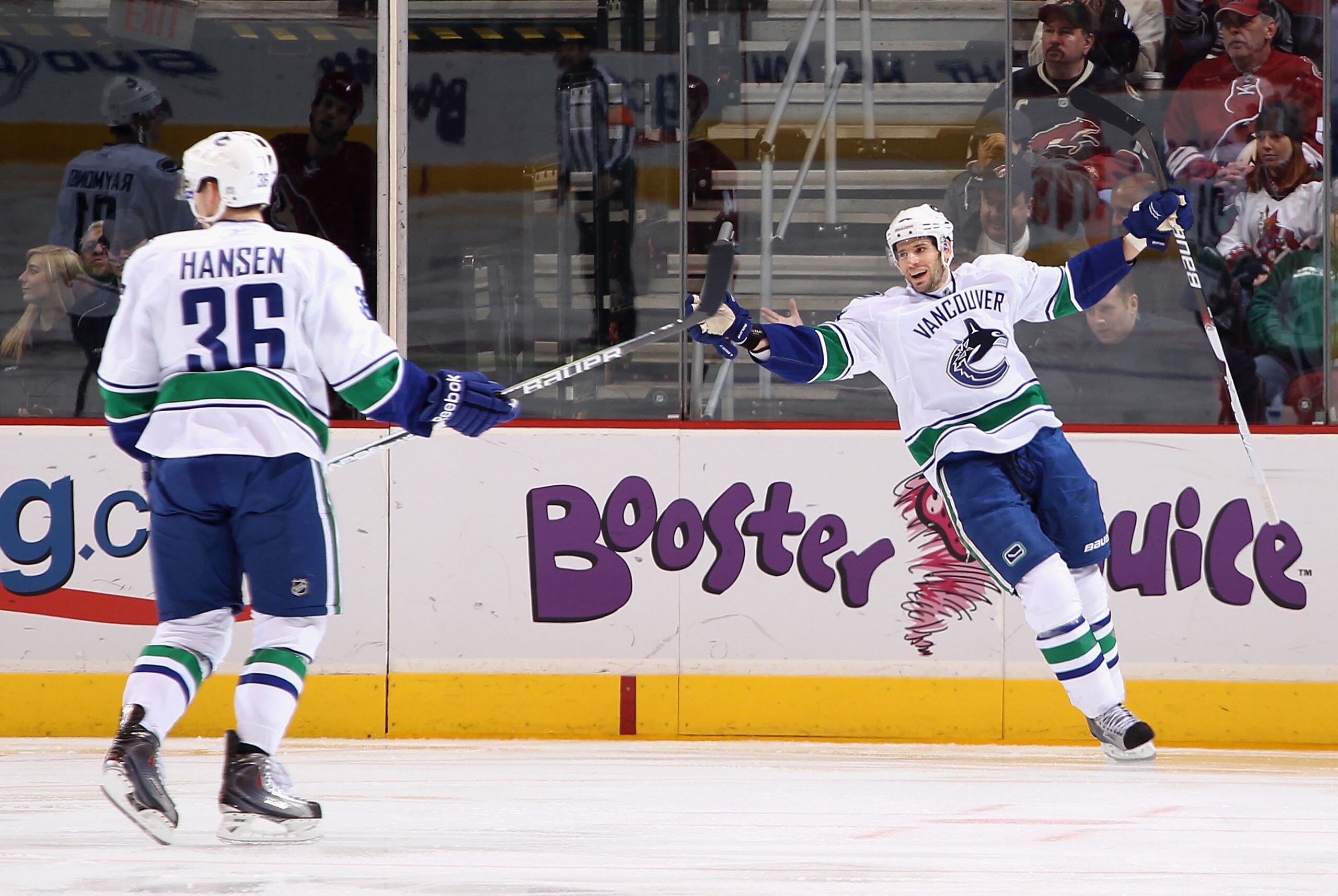 GLENDALE, AZ - FEBRUARY 02:  Jannik Hansen #36 and Ryan Kesler #17 of the Vancouver Canucks celebrate after Hansen scored a second period goal against the Phoenix Coyotes during the NHL game at Jobing.com Arena on February 2, 2011 in Glendale, Arizona.  (