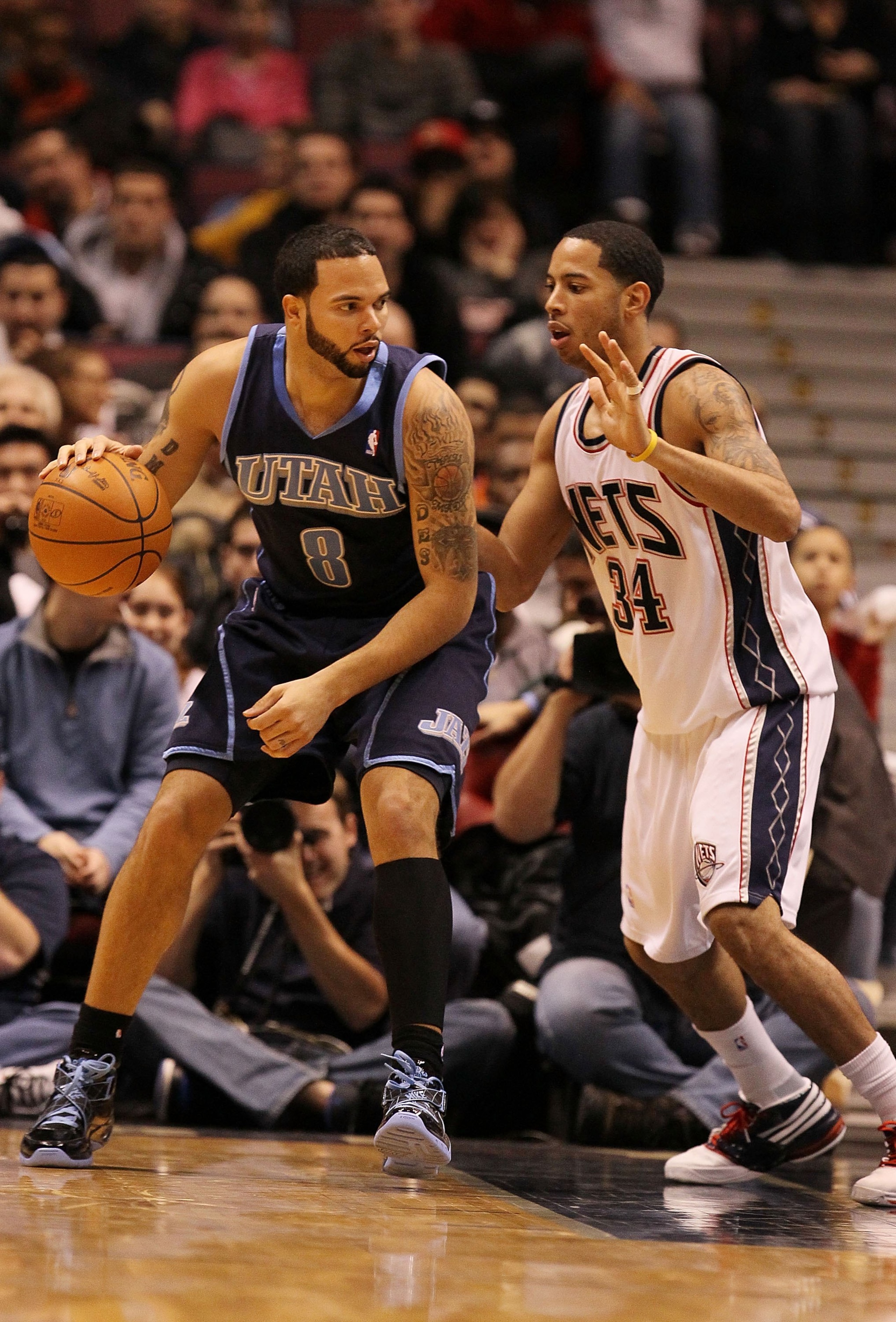 EAST RUTHERFORD, NJ - DECEMBER 16:  Devin Harris #34 of the New Jersey Nets guards Deron Williams #8 of The Utah Jazz during their game on December 16th, 2009 at The Izod Center in East Rutherford, New Jersey.  NOTE TO USER: User expressly acknowledges an