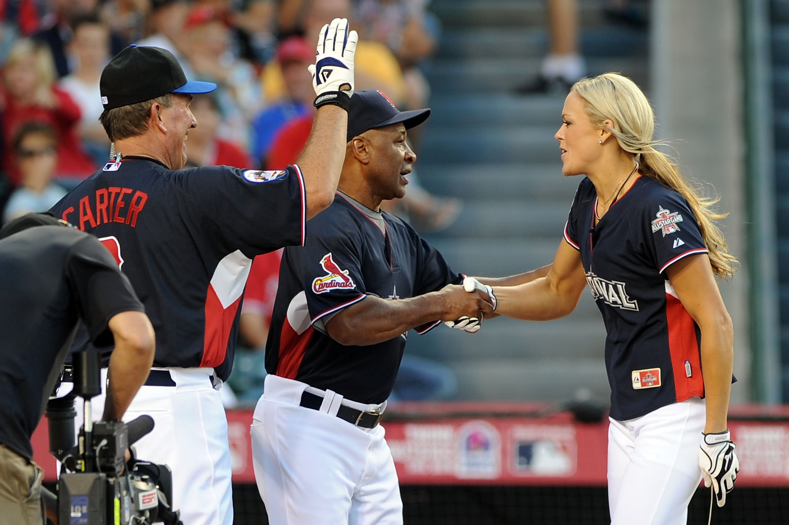 ANAHEIM, CA - JULY 11:  Former MLB player Gary Carter and former MLB player Ozzie Smith congratulate Softball Olympic gold medalist Jennie Finch after she hit a home run during the MLB All Star Game Celebrity Softball Game at Angels Stadium of Anaheim on 