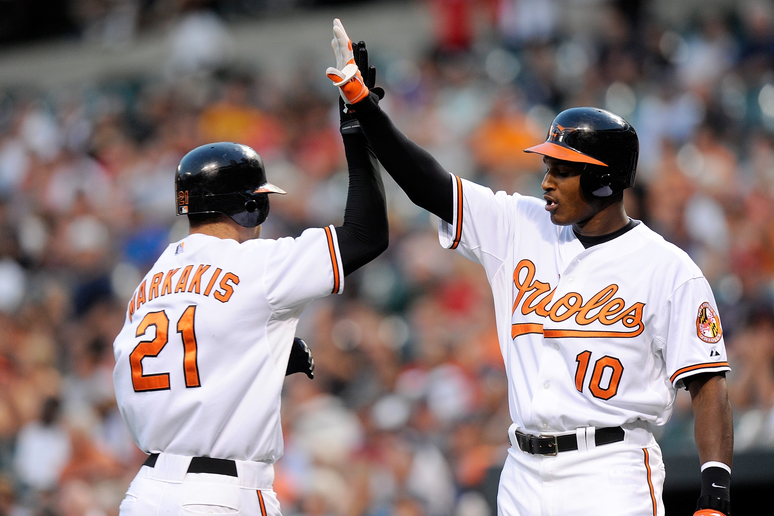 BALTIMORE - AUGUST 31:  Nick Markakis #21 of the Baltimore Orioles is congratulated by teammate Adam Jones #10 after scoring in the first inning against the Boston Red Sox at Camden Yards on August 31, 2010 in Baltimore, Maryland.  (Photo by Greg Fiume/Ge