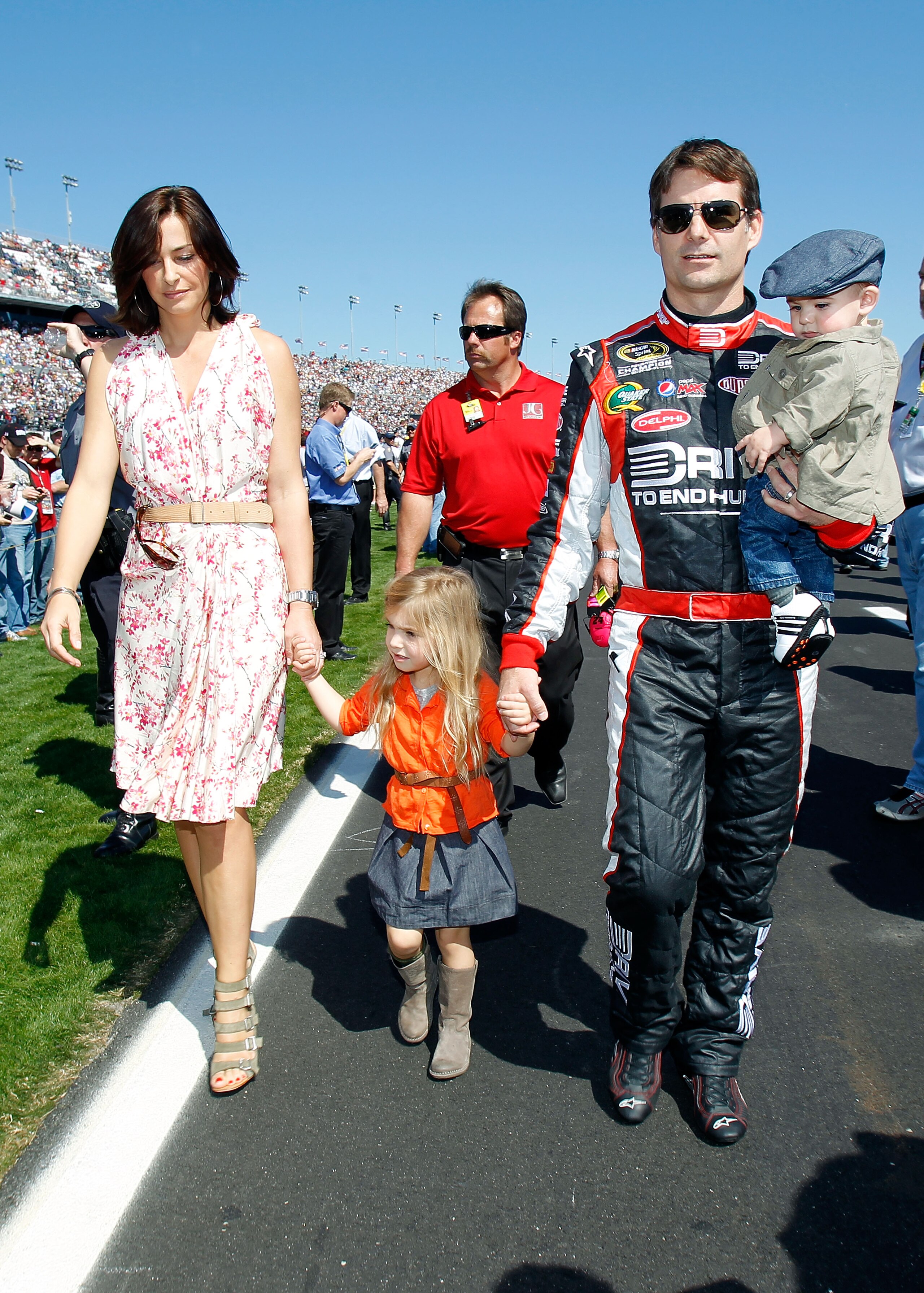 DAYTONA BEACH, FL - FEBRUARY 20:  Jeff Gordon, driver of the #24 Drive to End Hunger Chevrolet, walks with his daughter Ella Sophia and wife Ingrid Vandebosch prior to the start of the NASCAR Sprint Cup Series Daytona 500 at Daytona International Speedway