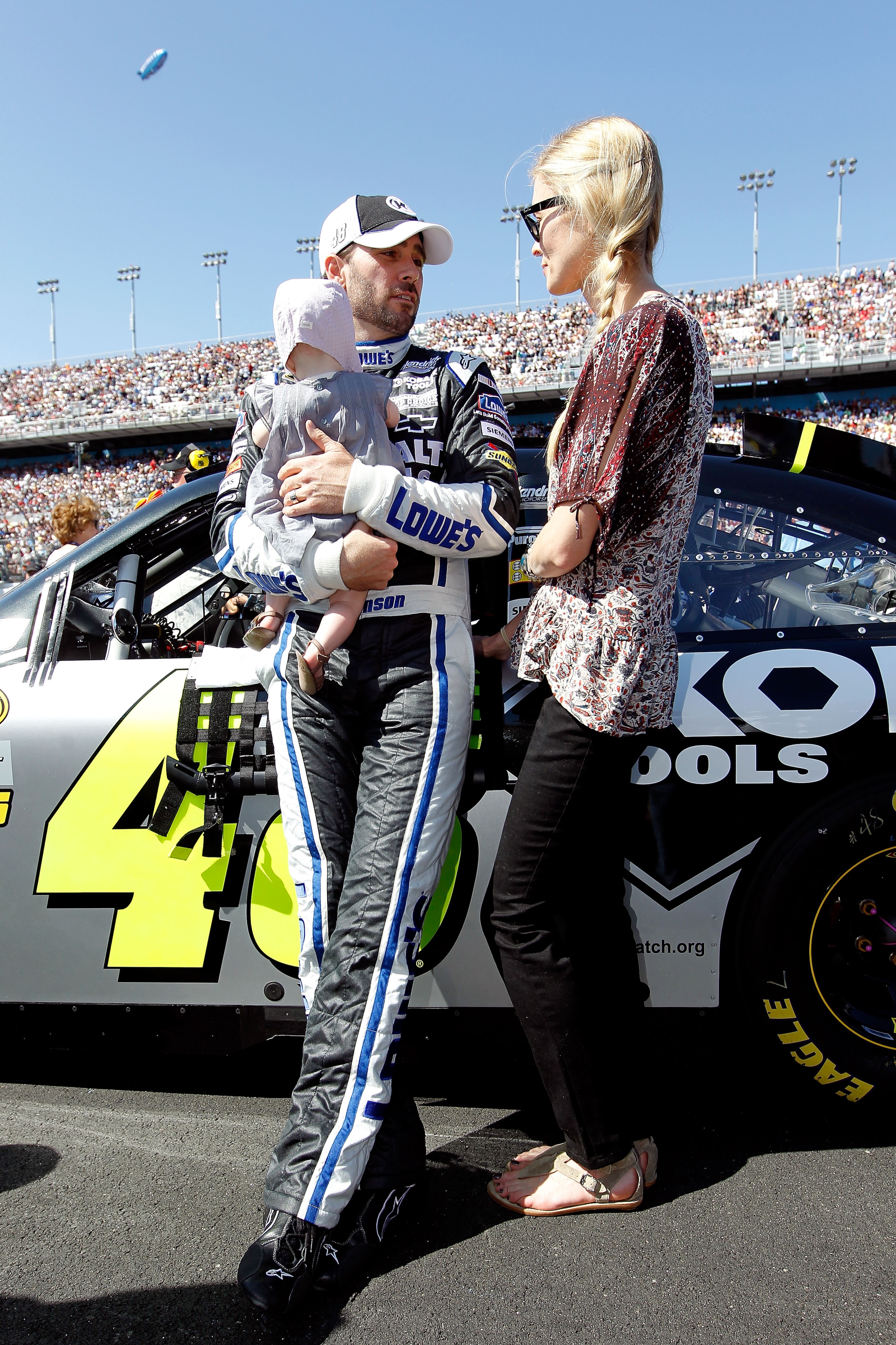 DAYTONA BEACH, FL - FEBRUARY 20:  Jimmie Johnson, driver of the #48 Lowe's Chevrolet, his wife Chandra and their daughter Genevieve Marie stand on the grid during pre-race ceremonies for the NASCAR Sprint Cup Series Daytona 500 at Daytona International Sp